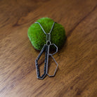 Image showcasing a sterling silver and spinel pendant necklace with a geometric design by North Carolina jewelry artist Erica Bailey