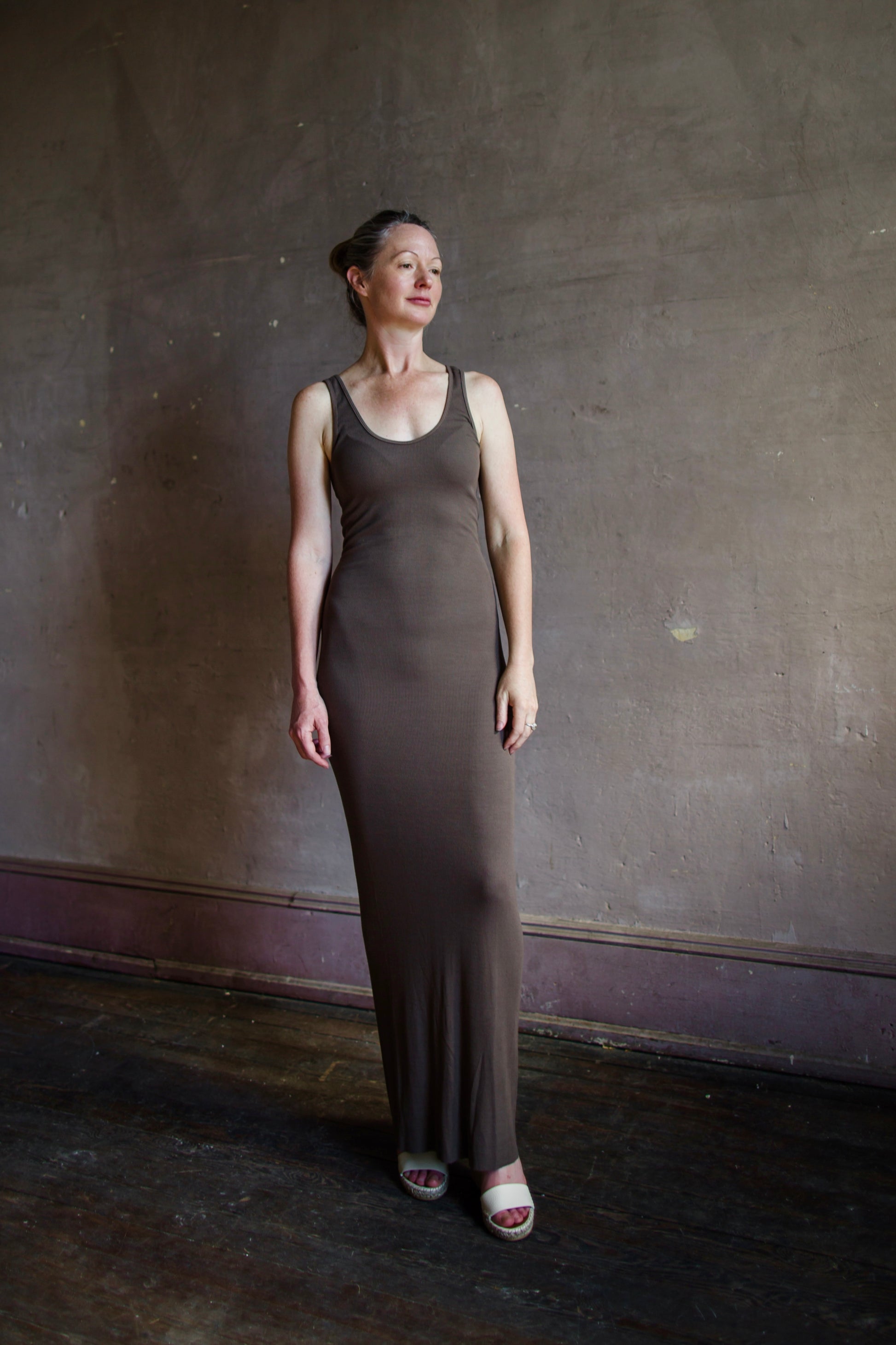 Image featuring a woman wearing the soft rib maxi dress from Enza Costa with a body-hugging fit and flattering stretch in mushroom color.