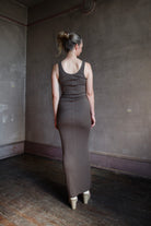 Image featuring a woman wearing the soft rib maxi dress from Enza Costa with a body-hugging fit and flattering stretch in mushroom color.