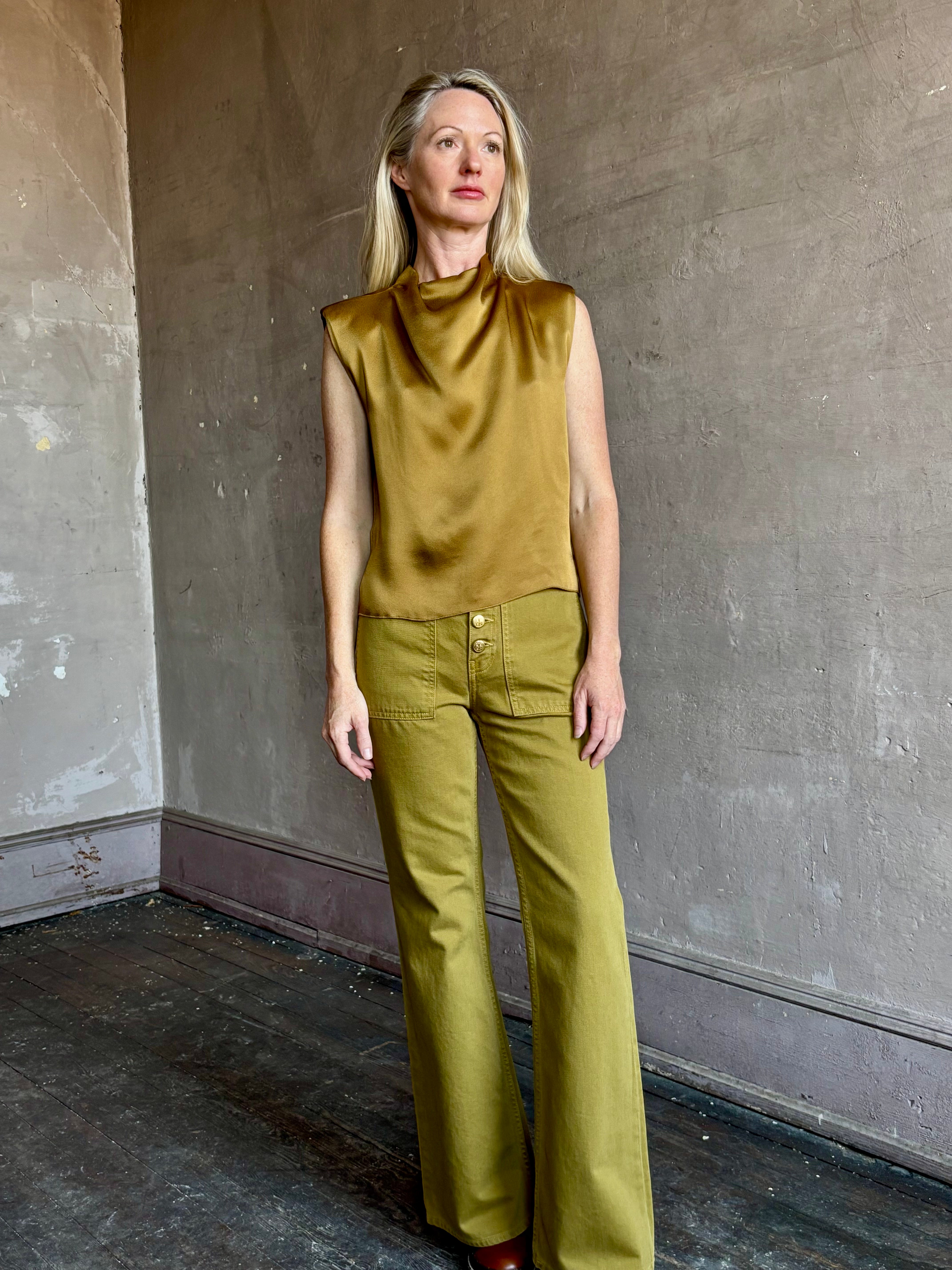 Image of mature woman wearing luxury Italian designer FORTE FORTE Envers Satin Crater-Neck sleeveless Shirt in matte Antique Gold 