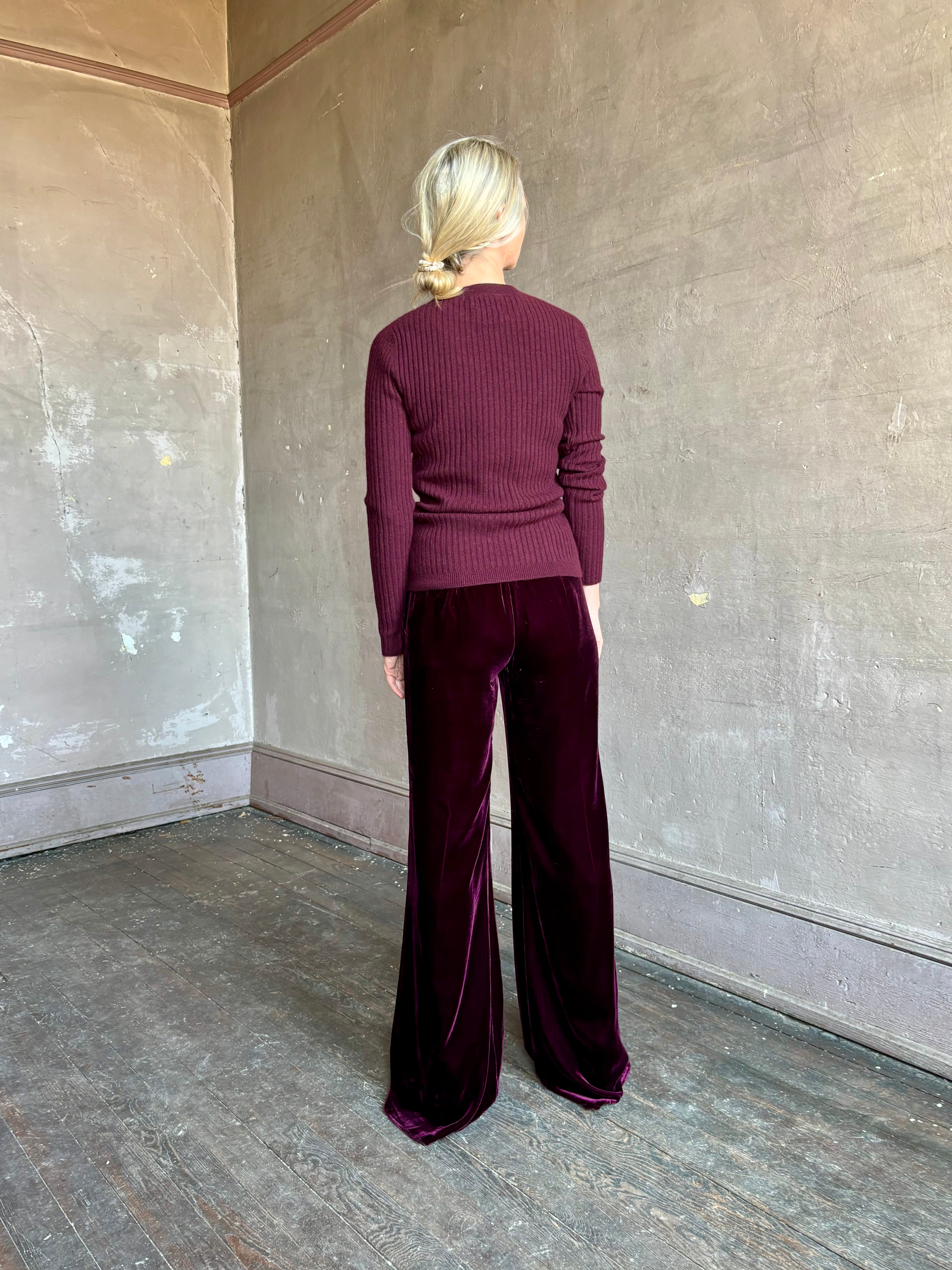Image of mature woman wearing luxury Italian designer FORTE FORTE Plain Velvet Flare Pants in Bordeaux with flat front and flare leg