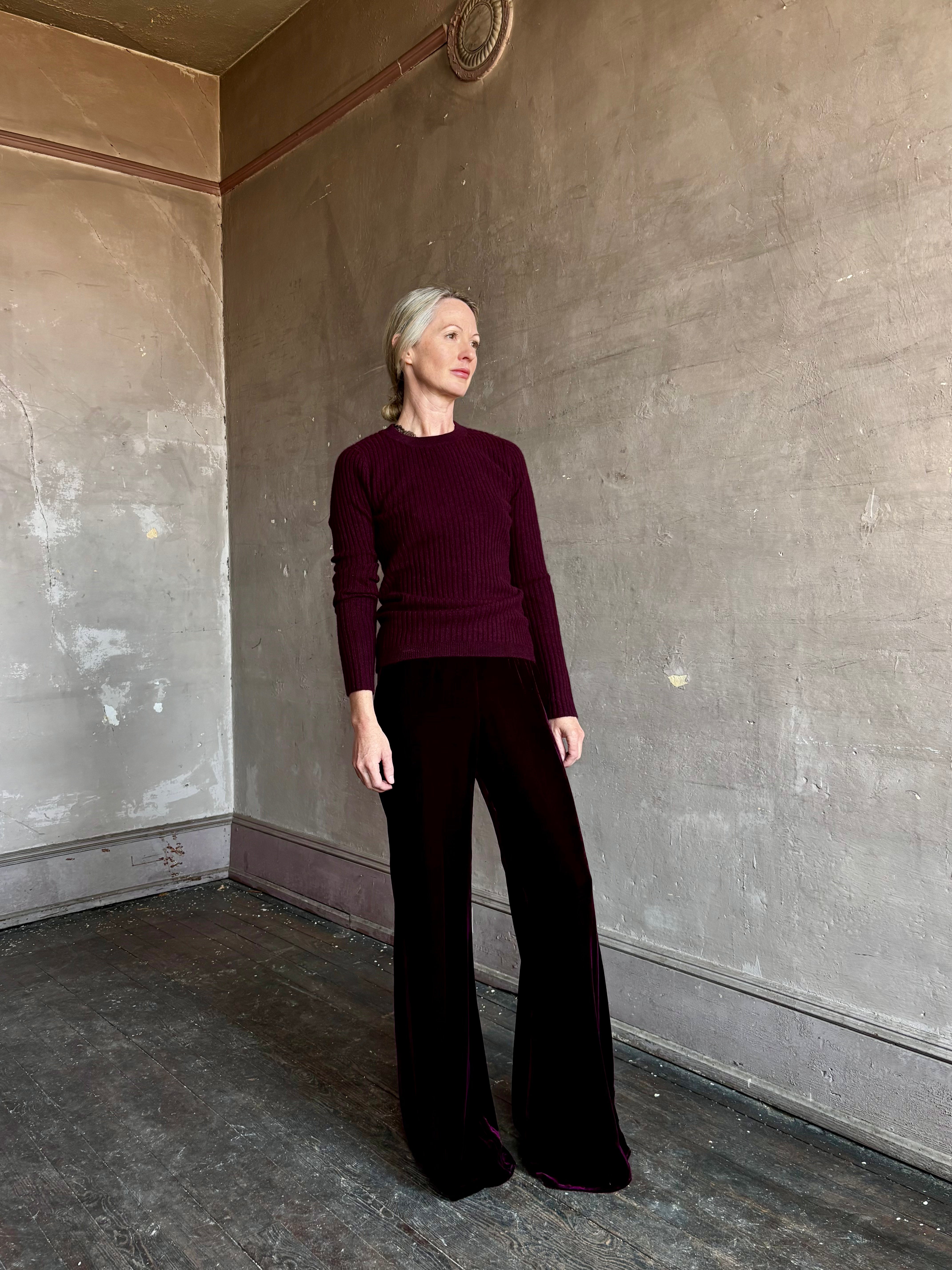 Image of mature woman wearing luxury Italian designer FORTE FORTE Plain Velvet Flare Pants in Bordeaux with flat front and flare leg