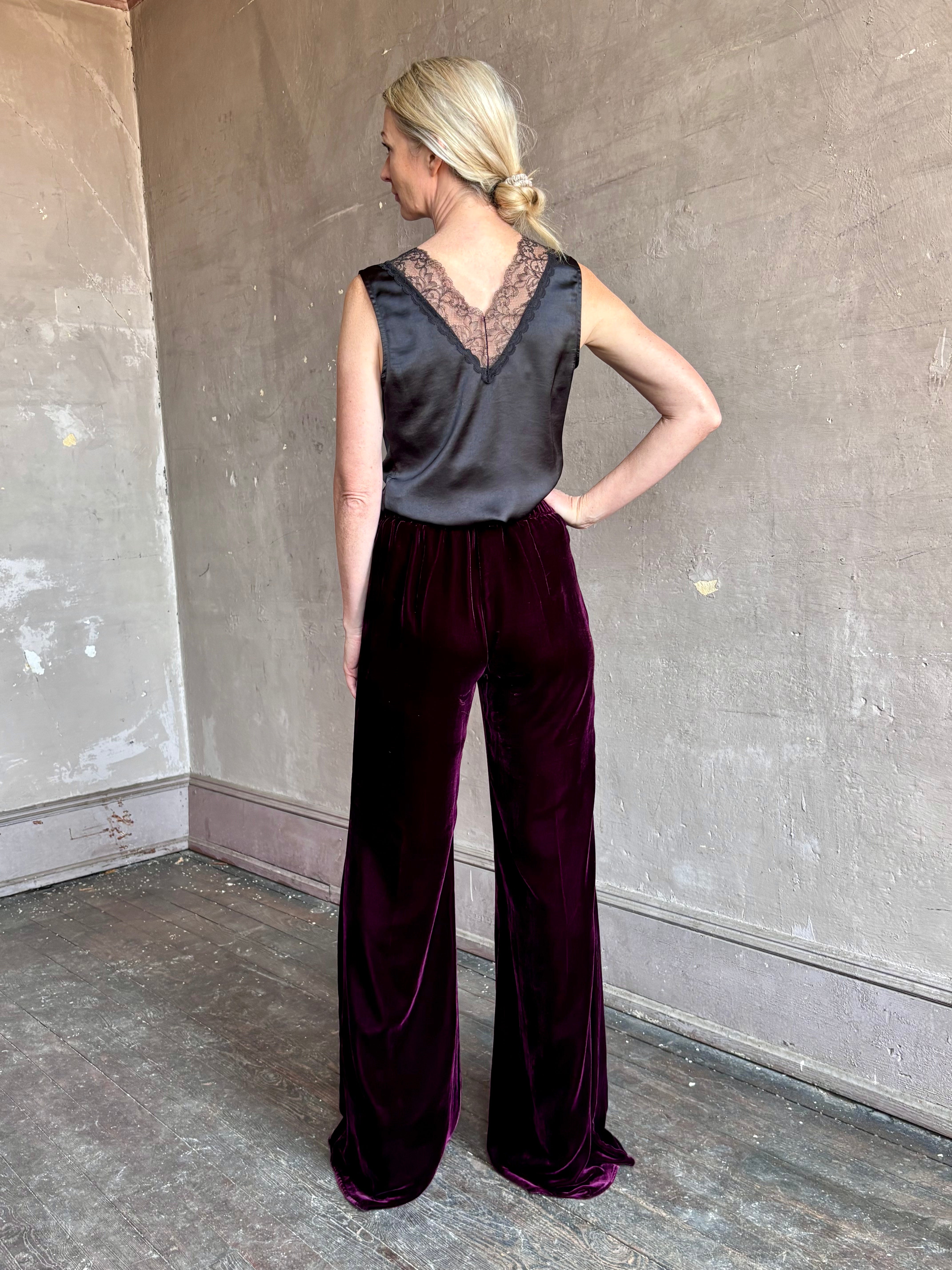 Image of mature woman wearing luxury Italian designer FORTE FORTE Plain Velvet Flare Pants in Bordeaux with flat front and flare leg