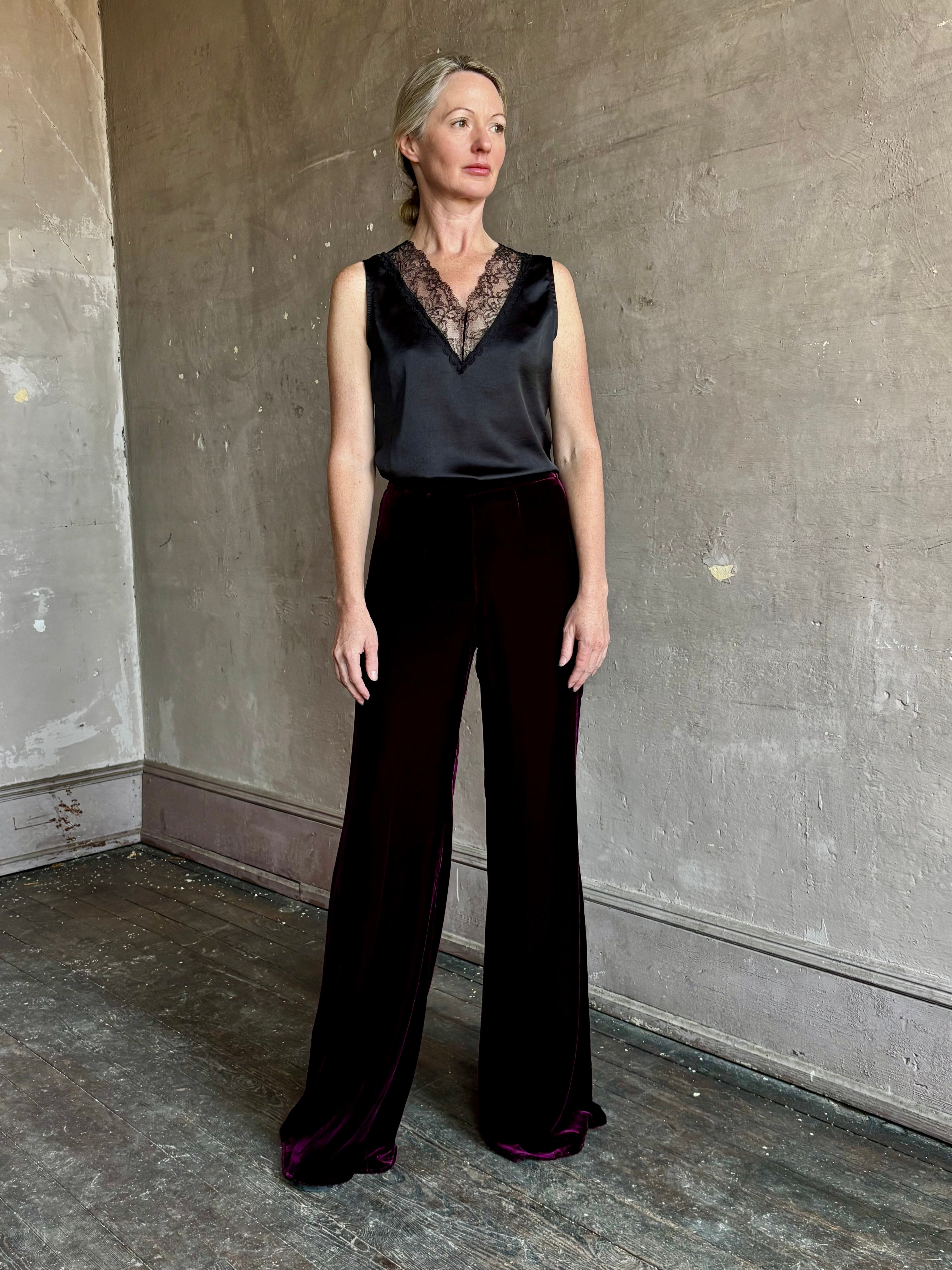 Image of mature woman wearing luxury Italian designer FORTE FORTE Plain Velvet Flare Pants in Bordeaux with flat front and flare leg