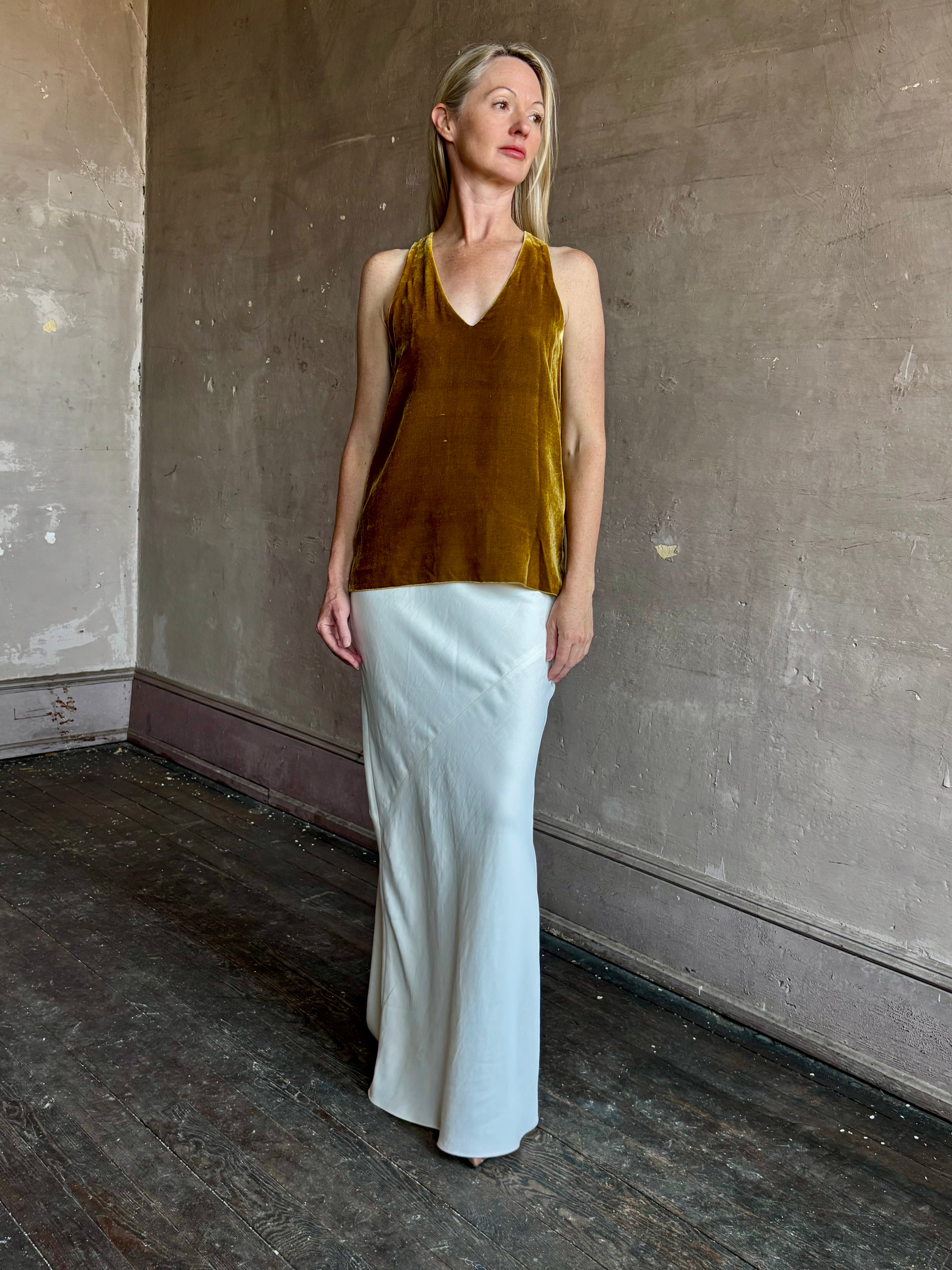 Image of mature woman wearing luxury Italian designer FORTE FORTE Plain sleeveless Velvet V Neck Top in Antique Gold with exquisite draping