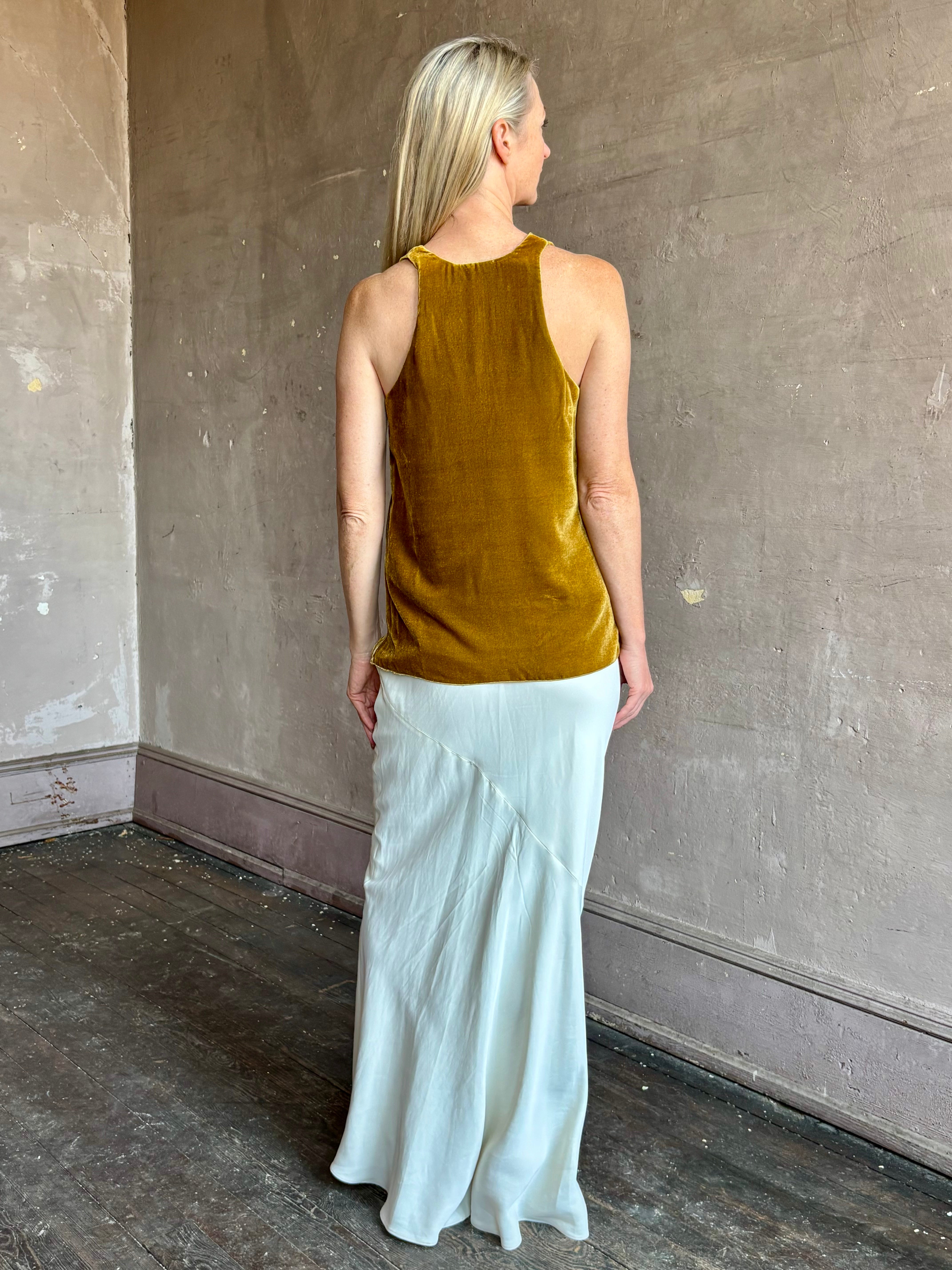 Image of mature woman wearing luxury Italian designer FORTE FORTE Plain Velvet V Neck Top in Antique Gold with exquisite draping