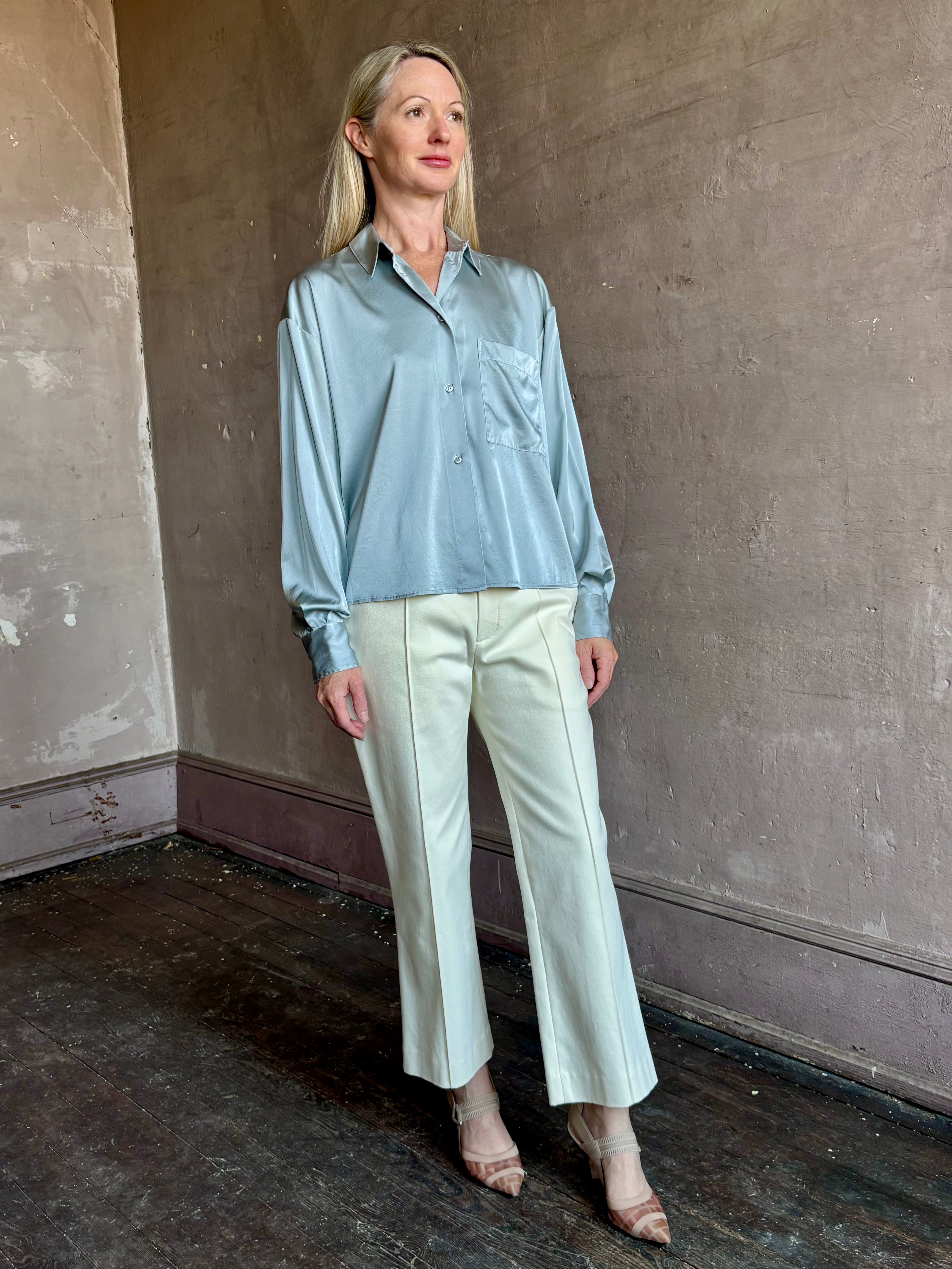 Image of mature woman wearing luxury Italian designer FORTE FORTE Stretch Silk Satin Cropped button down long sleeve Shirt in steel blue
