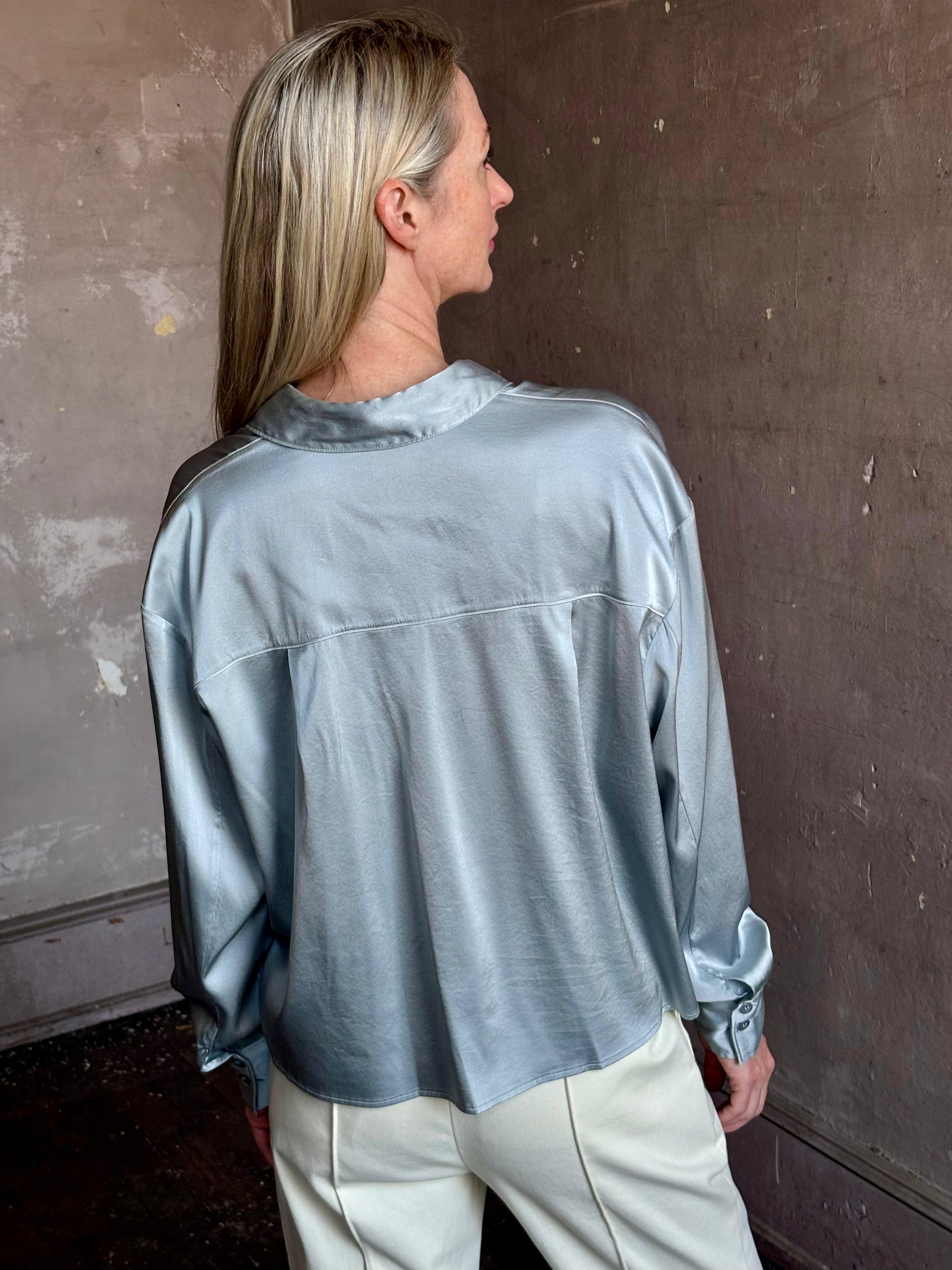 Image of mature woman wearing luxury Italian designer FORTE FORTE Stretch Silk Satin Cropped button down long sleeve Shirt in steel blue