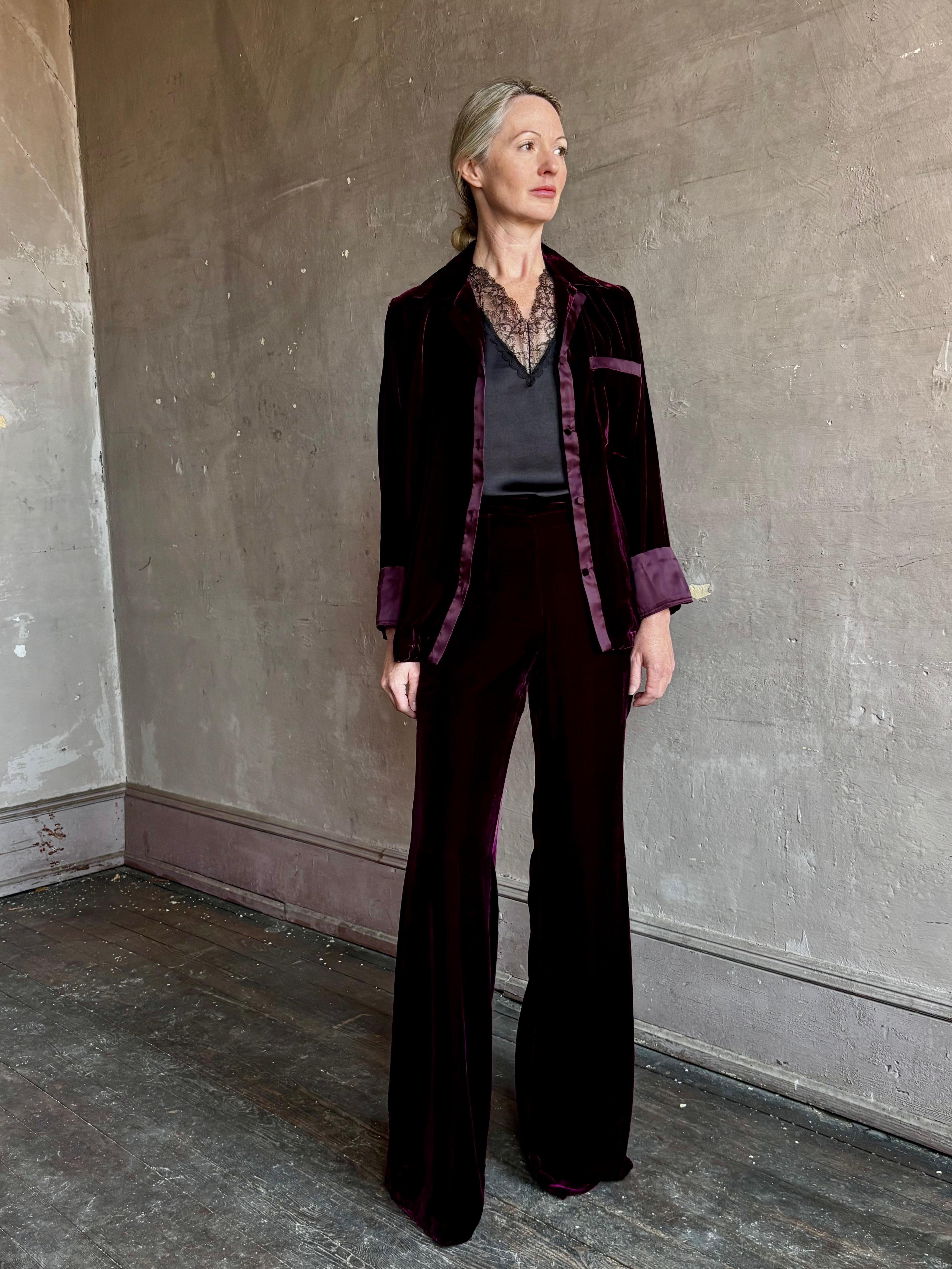 Image of mature woman wearing luxury Italian designer FORTE FORTE Plain Velvet Flare Pants in Bordeaux with flat front and flare leg