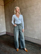 Image of woman wearing Italian knitwear by FORTE FORTE Superfine Merino Ribbed Cardigan in Neve off-white with v-neck and long sleeves