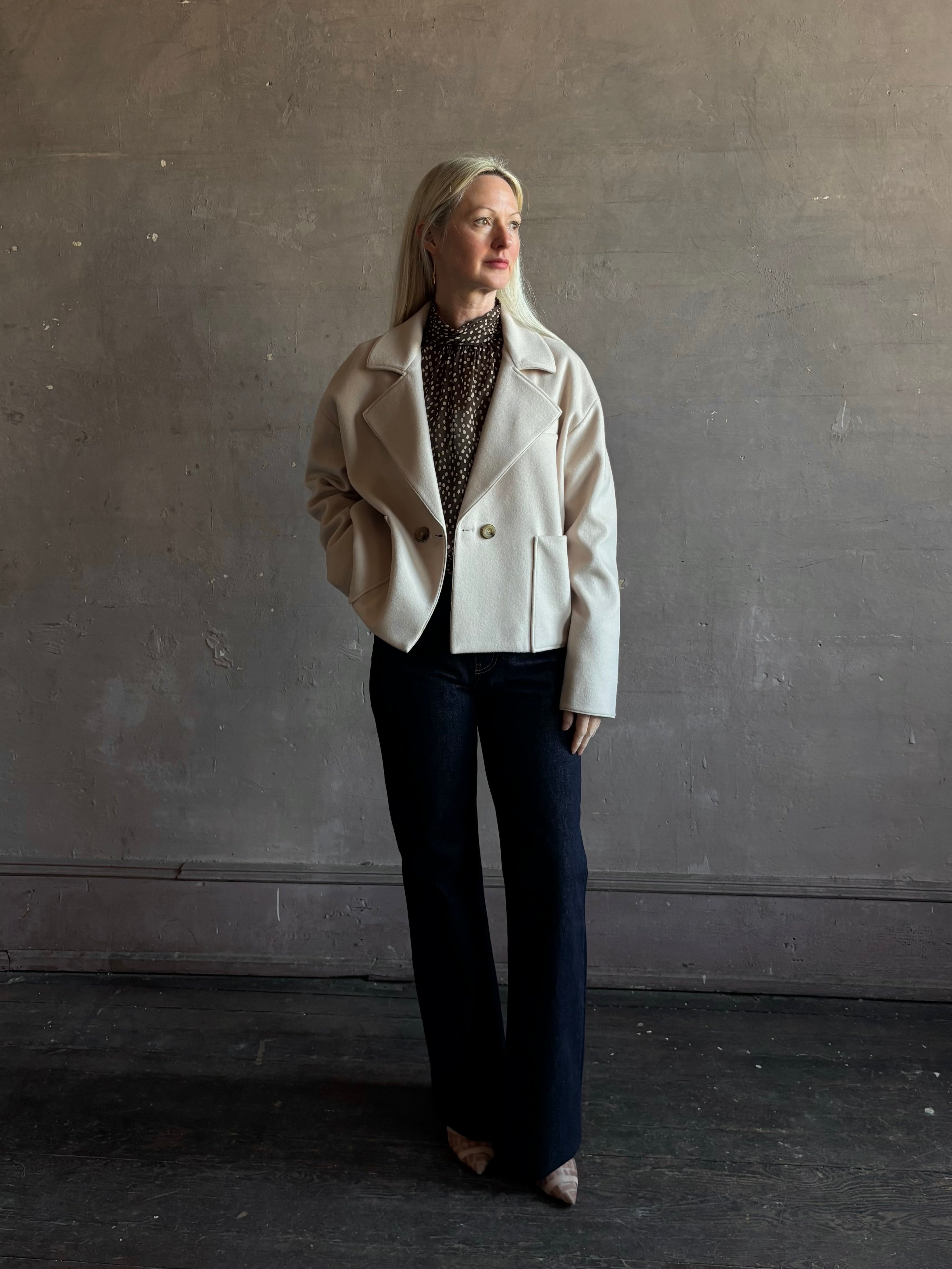 Mature woman wearing expertly tailored Forte Forte beige jacket in premium virgin wool and cashmere 
