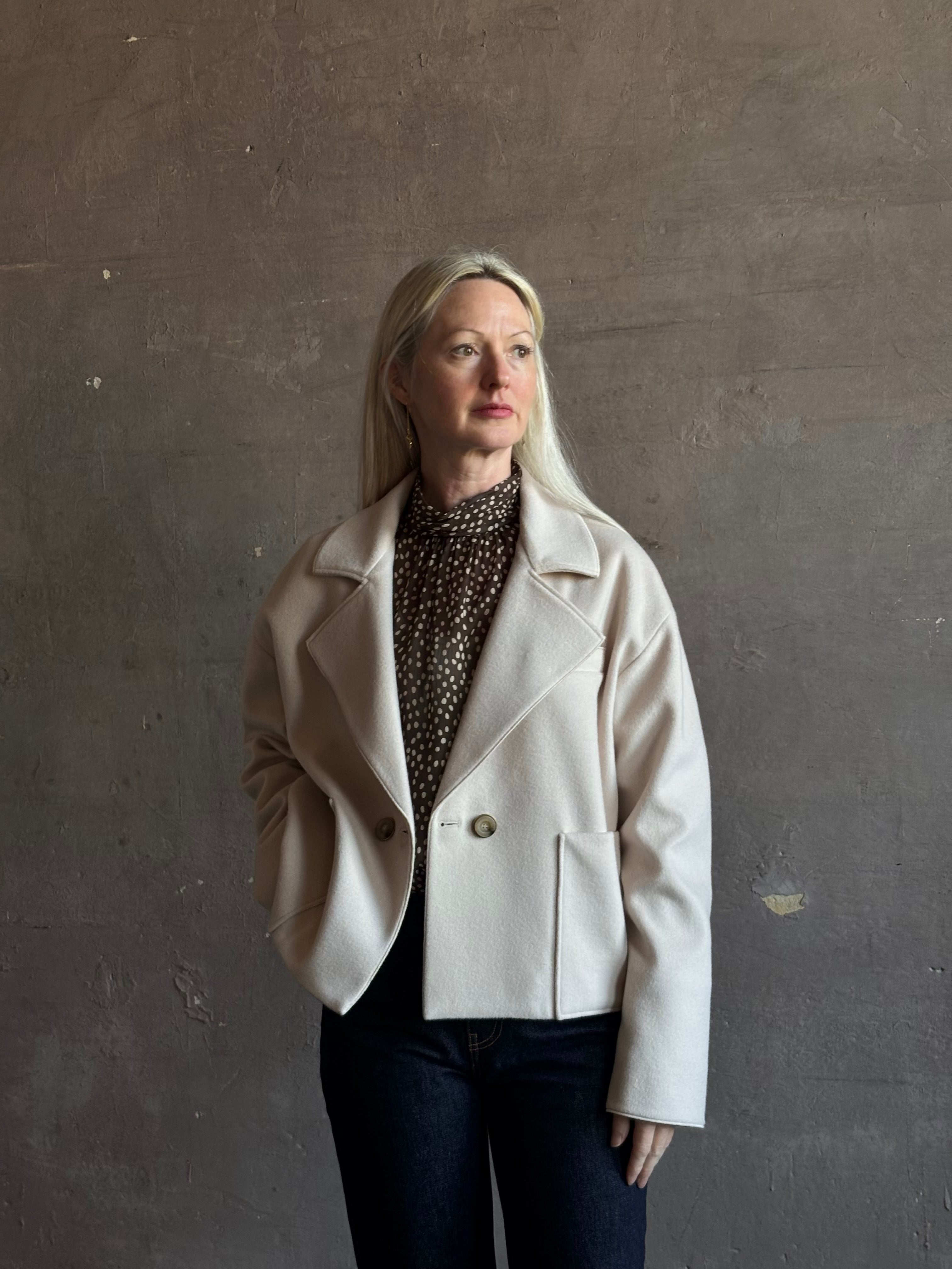 Mature woman wearing expertly tailored Forte Forte beige jacket in premium virgin wool and cashmere 