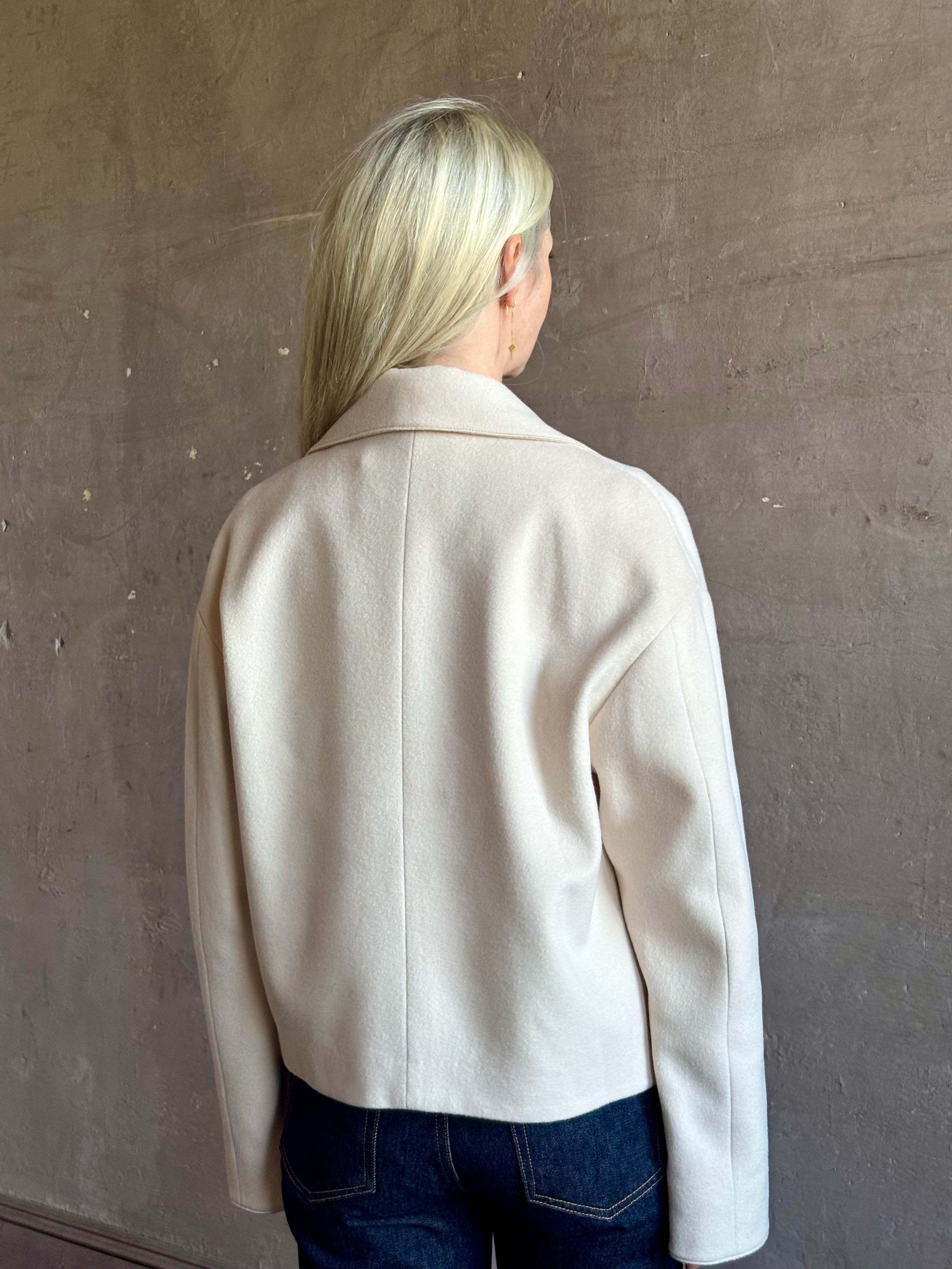 Mature woman wearing expertly tailored Forte Forte beige jacket in premium virgin wool and cashmere 