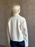 Mature woman wearing expertly tailored Forte Forte beige jacket in premium virgin wool and cashmere 