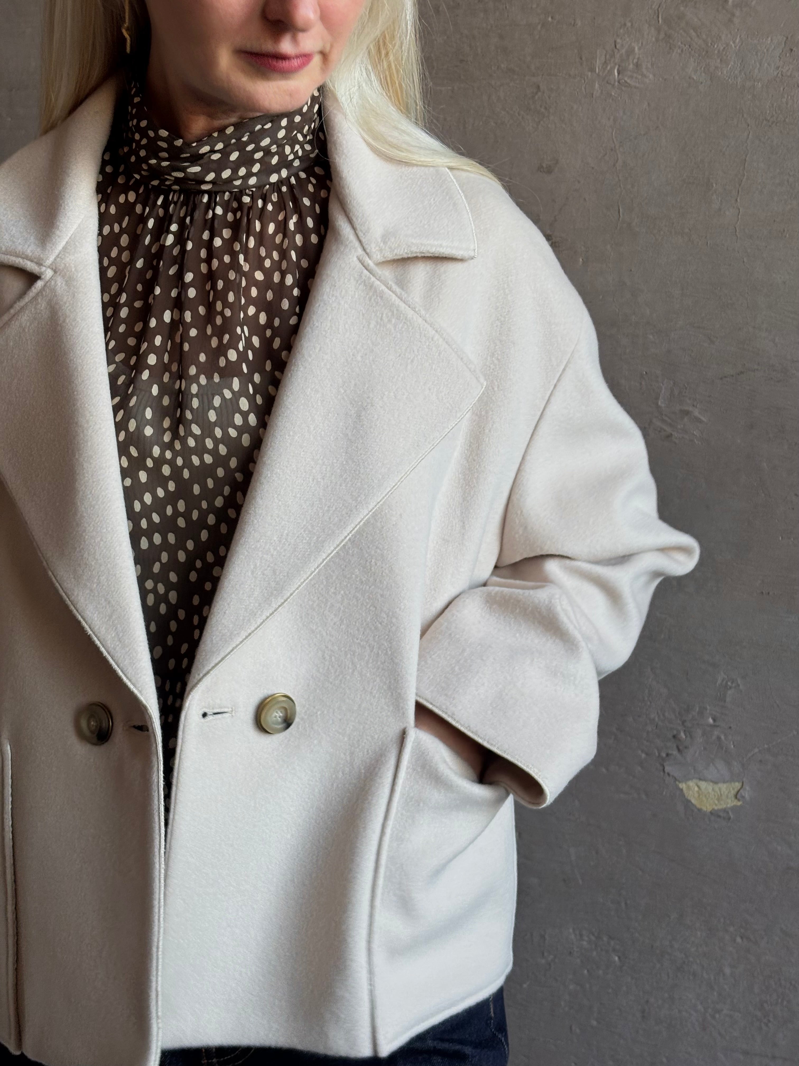 Mature woman wearing expertly tailored Forte Forte beige jacket in premium virgin wool and cashmere 