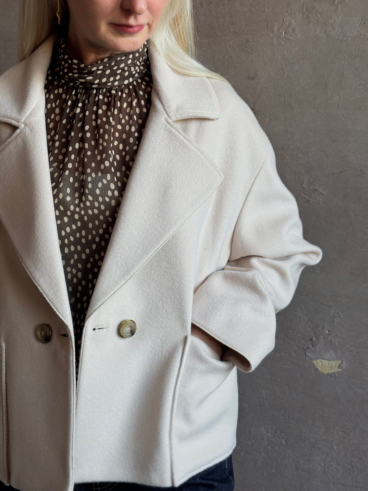 Mature woman wearing expertly tailored Forte Forte beige jacket in premium virgin wool and cashmere 