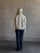 Mature woman wearing expertly tailored Forte Forte beige jacket in premium virgin wool and cashmere 