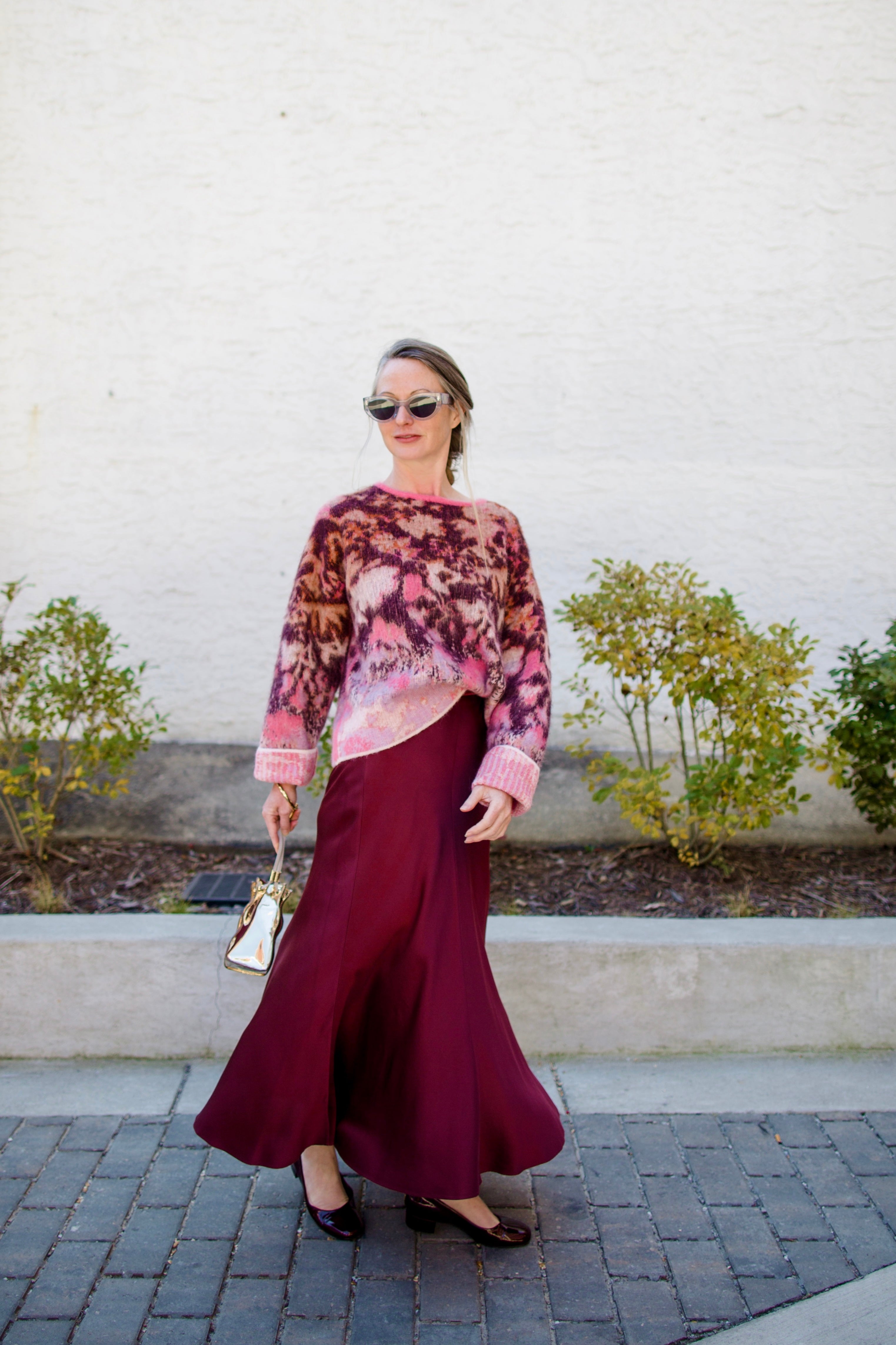 Image featuring a woman wearing the bloom mist mohair and alpaca sweater by Forte Forte with a crew neckline and slightly boxy fit in cerise multicolor floral print.