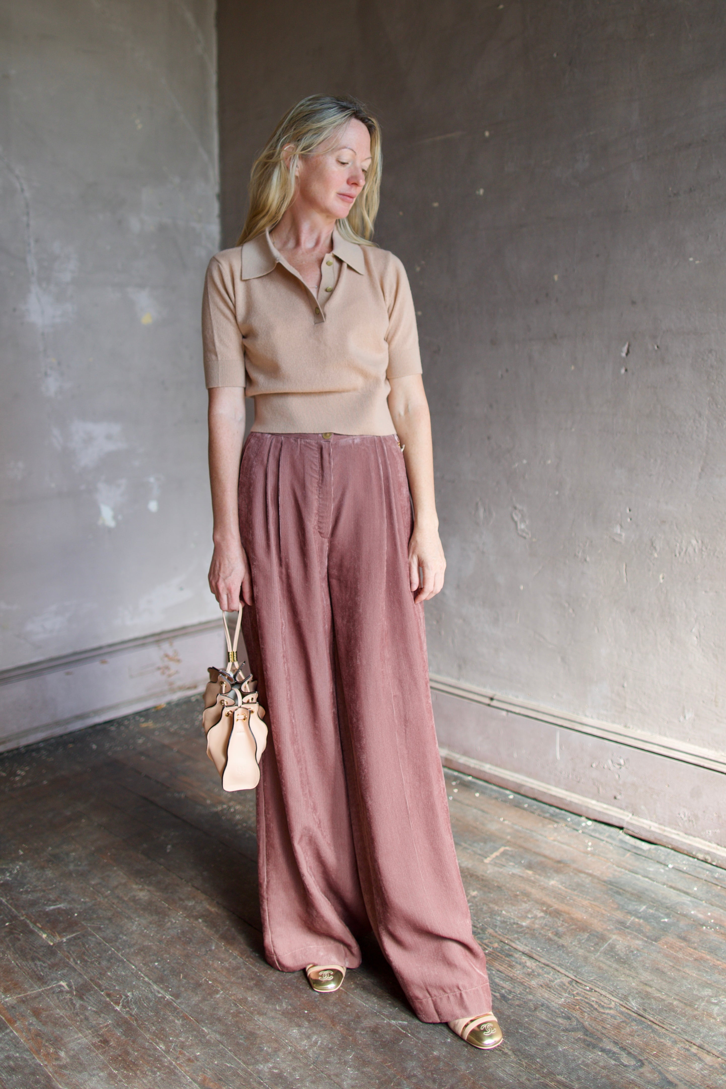 Model wearing luxury Italian designer Forte Forte wool and cashmere short sleeve polo sweater with short sleeves