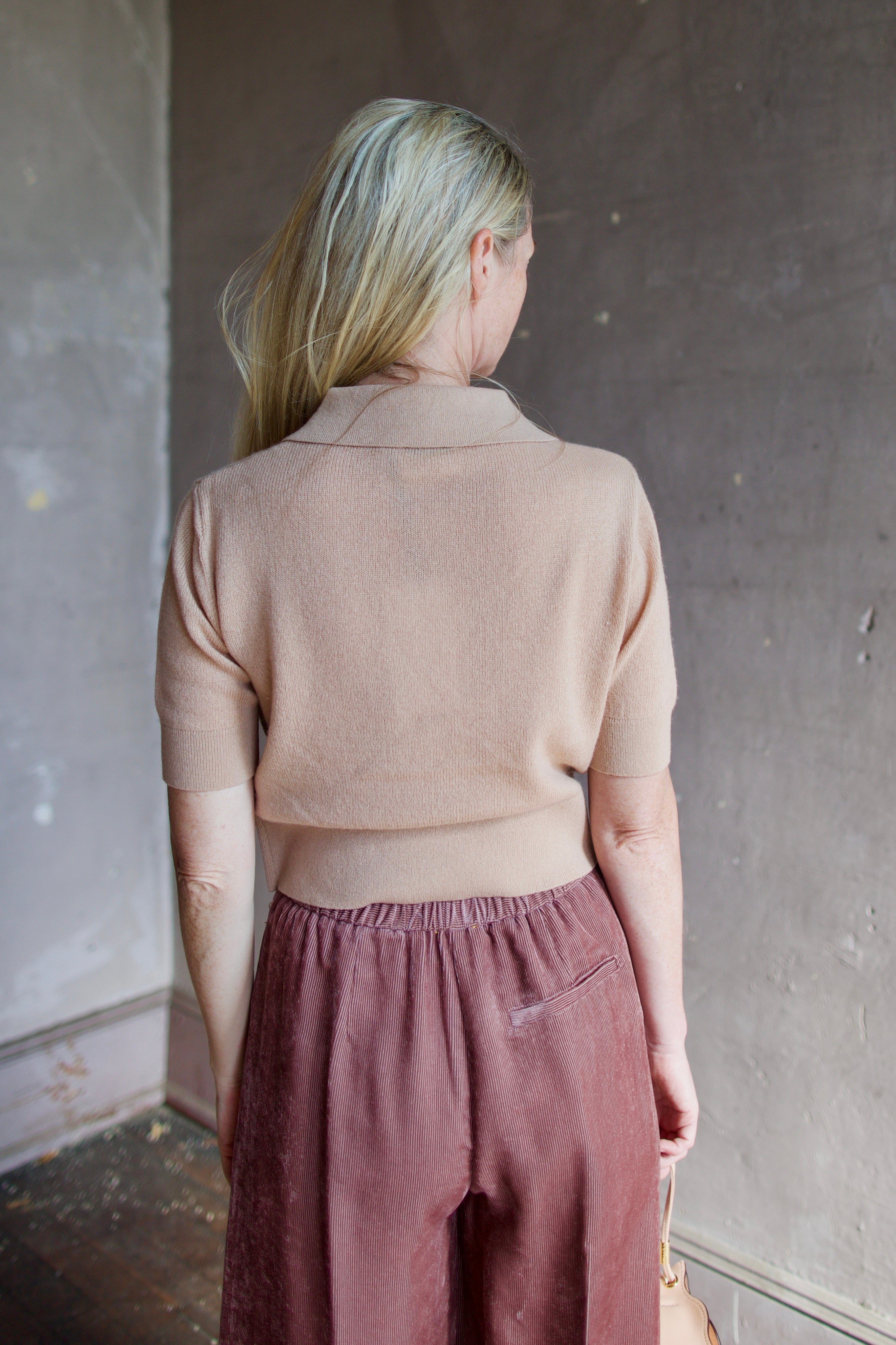 Model wearing luxury Italian designer Forte Forte wool and cashmere short sleeve polo sweater with short sleeves