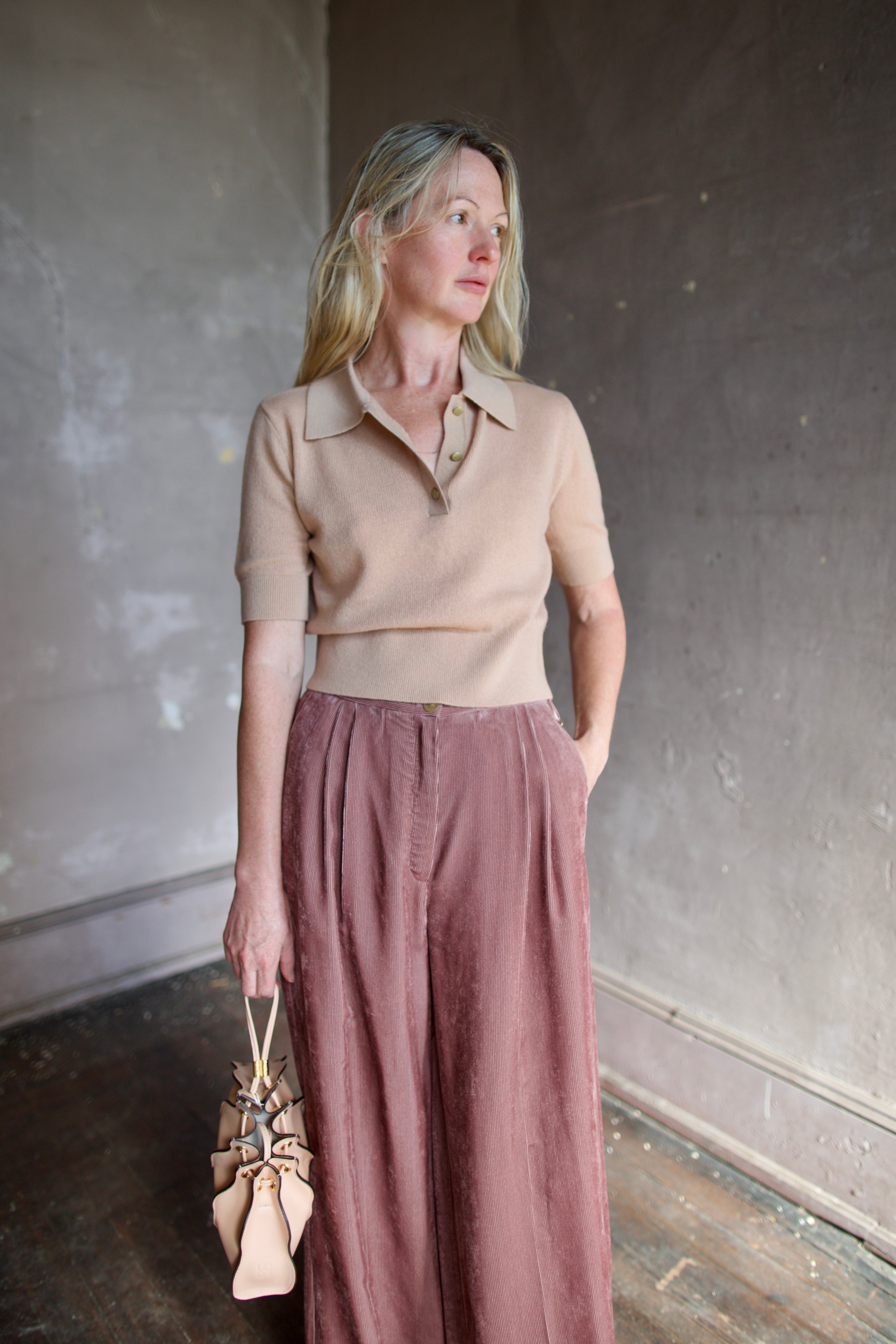 Model wearing luxury Italian designer Forte Forte wool and cashmere short sleeve polo sweater with short sleeves