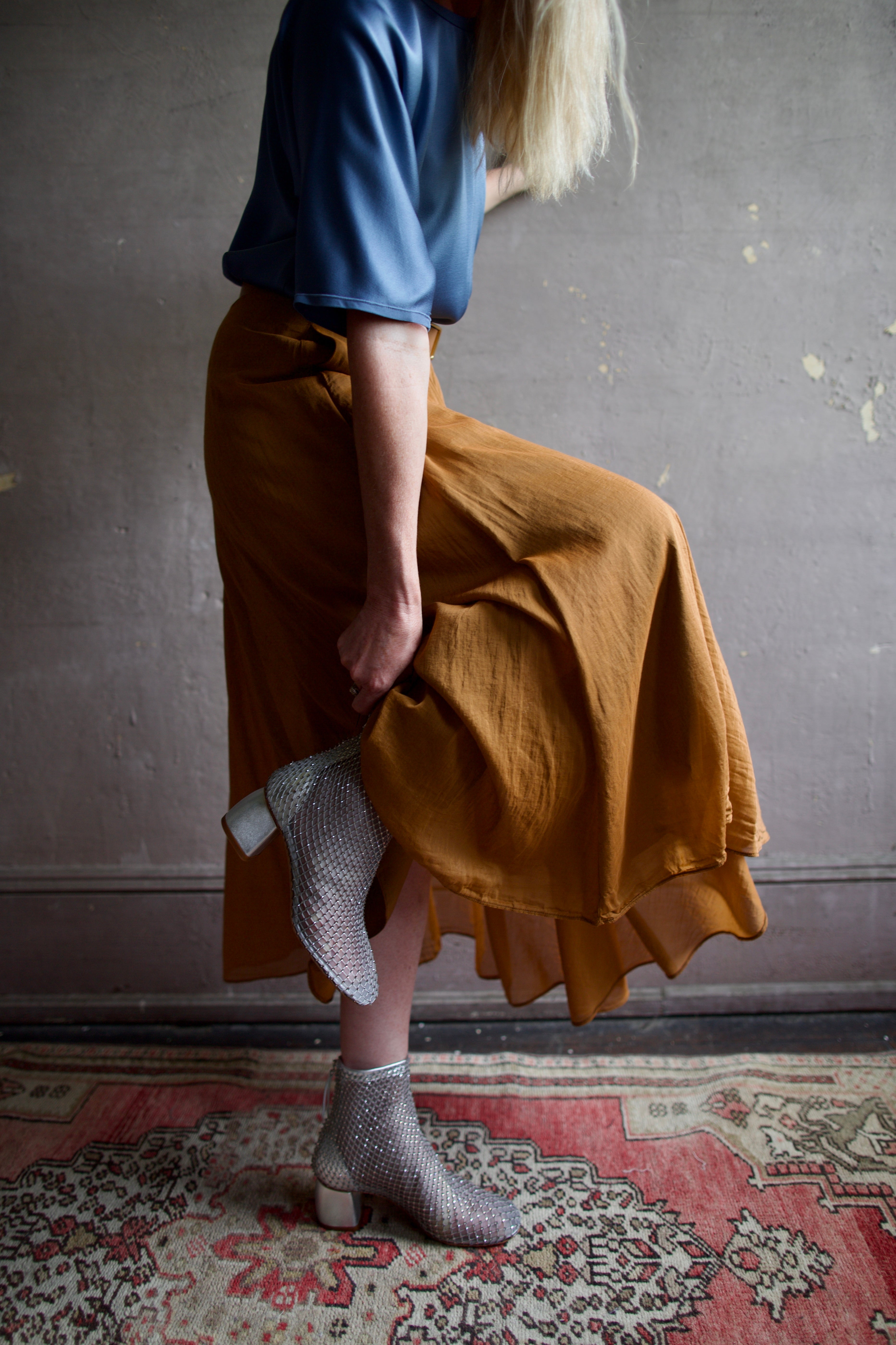 Senior model wearing luxury Italian designer Forte Forte mesh sheer silver ankle boot with elusive gleaming crystals.