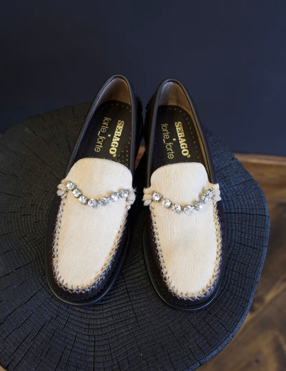 Image featuring the Forte Forte collaboration loafers with Sebago. They are brown leather with ivory horsehair accents and rhinestone detailing.