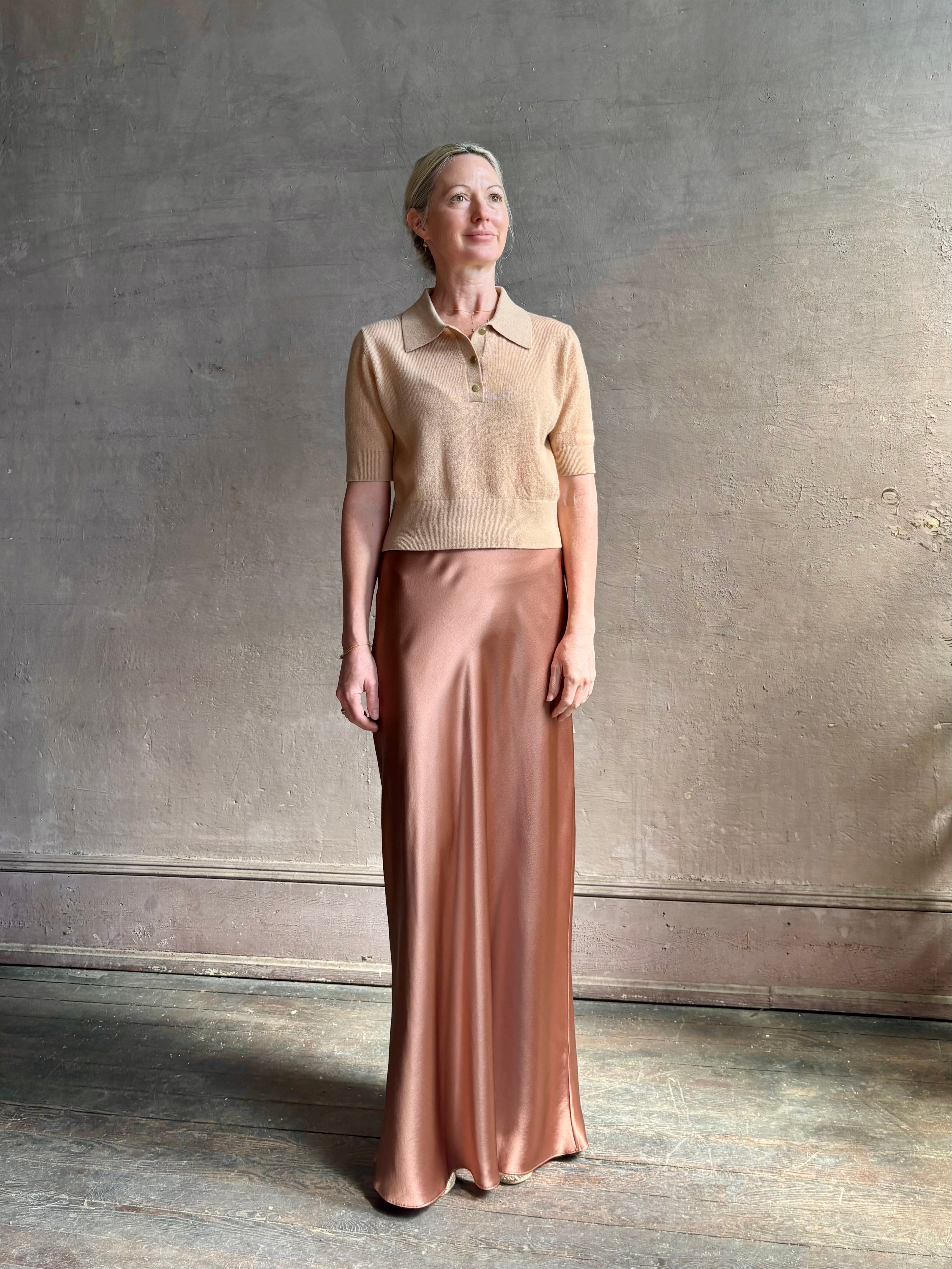 Mature woman wearing an elevated basic short sleeve polo sweater by luxury Italian designer Forte Forte rendered in a comfortable light weight wool and cashmere blend