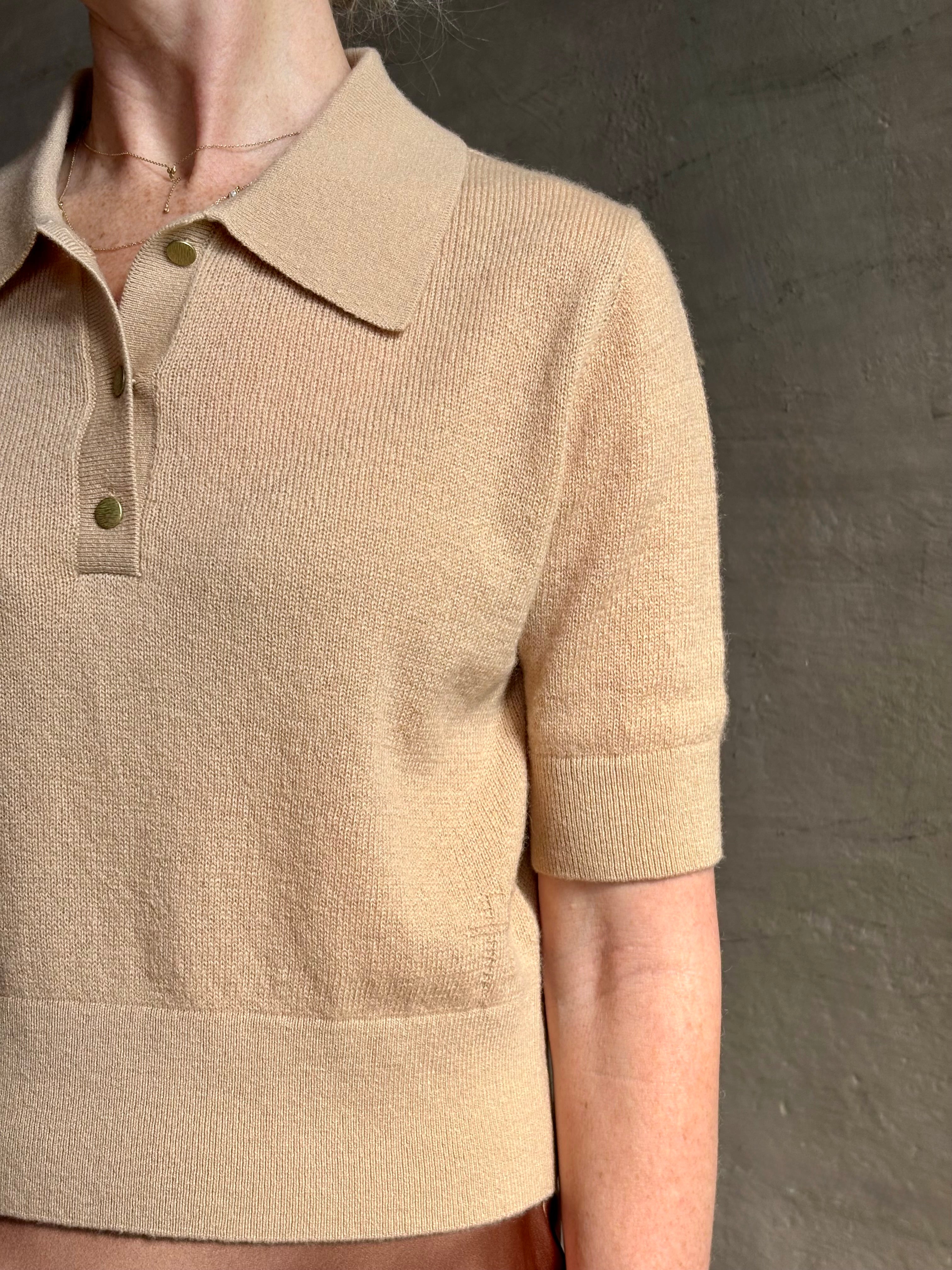 Mature woman wearing an elevated basic short sleeve polo sweater by luxury Italian designer Forte Forte rendered in a comfortable light weight wool and cashmere blend