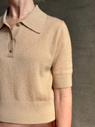 Mature woman wearing an elevated basic short sleeve polo sweater by luxury Italian designer Forte Forte rendered in a comfortable light weight wool and cashmere blend
