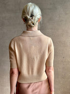 Mature woman wearing an elevated basic short sleeve polo sweater by luxury Italian designer Forte Forte rendered in a comfortable light weight wool and cashmere blend