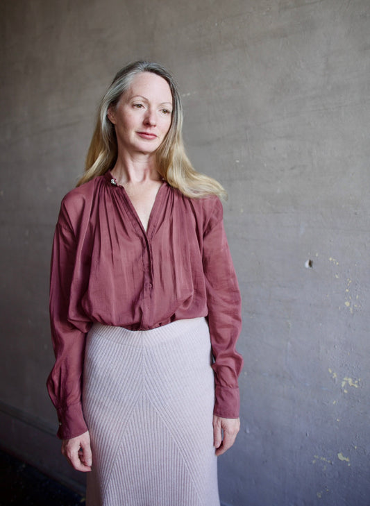 Image featuring a woman wearing the voile bohemian shirt by Forte Forte with a hook and eye closure and crystal embellishment at neckline and long sleeve button.