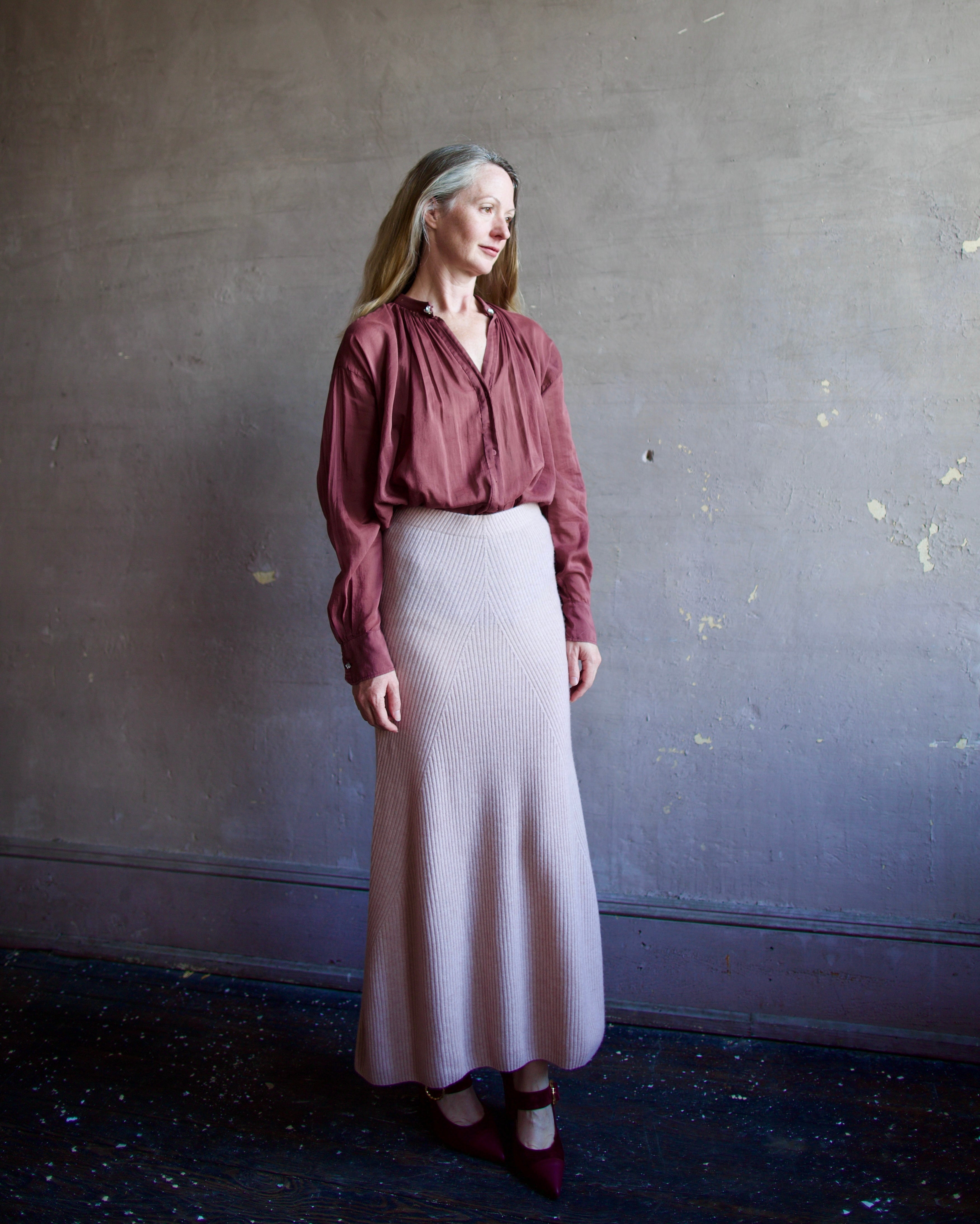 Image featuring a woman wearing the voile bohemian shirt by Forte Forte with a hook and eye closure and crystal embellishment at neckline and long sleeve button.