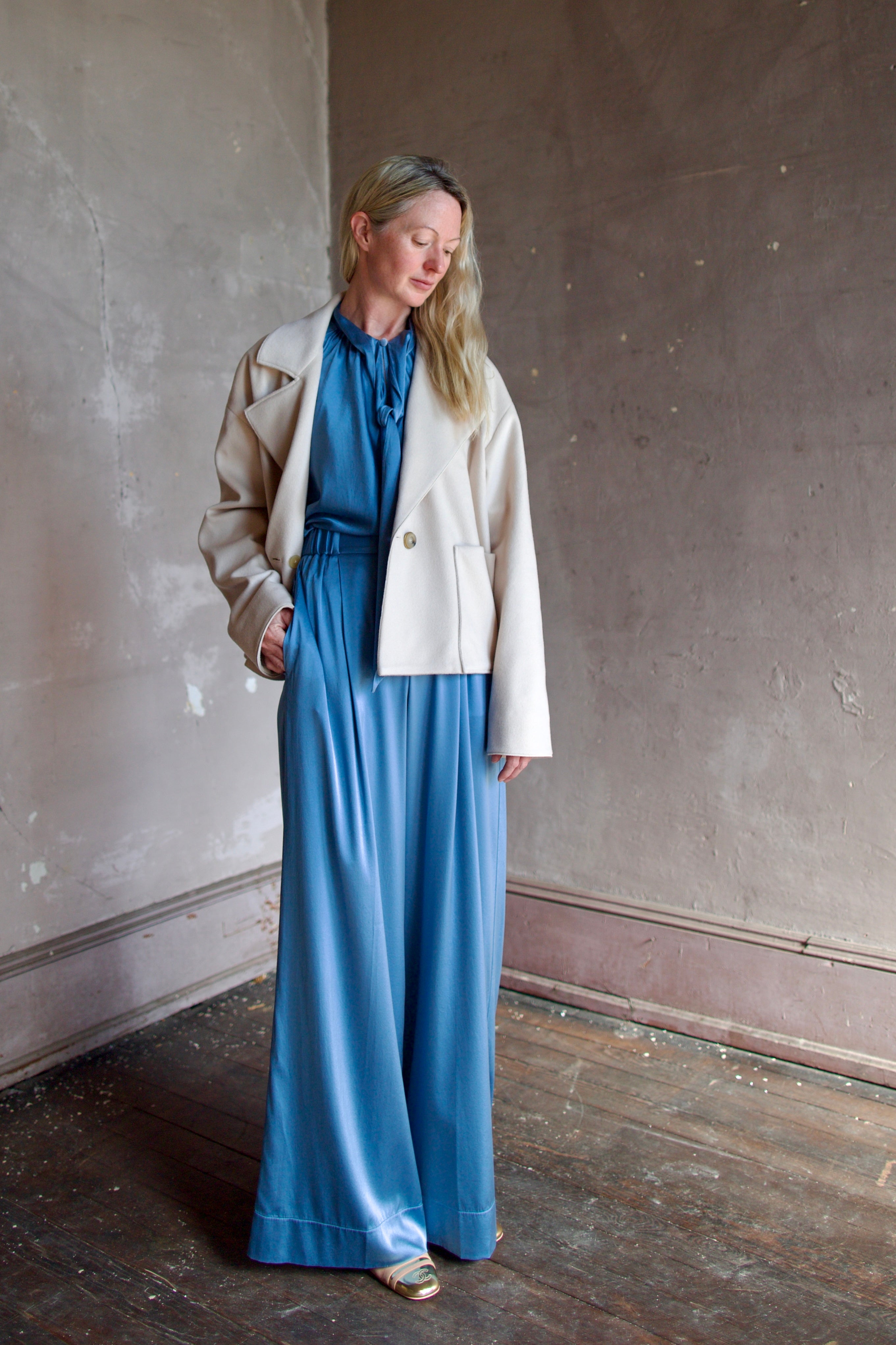 Model wearing expertly tailored Forte Forte beige jacket in premium virgin wool and cashmere with front pockets and button closure