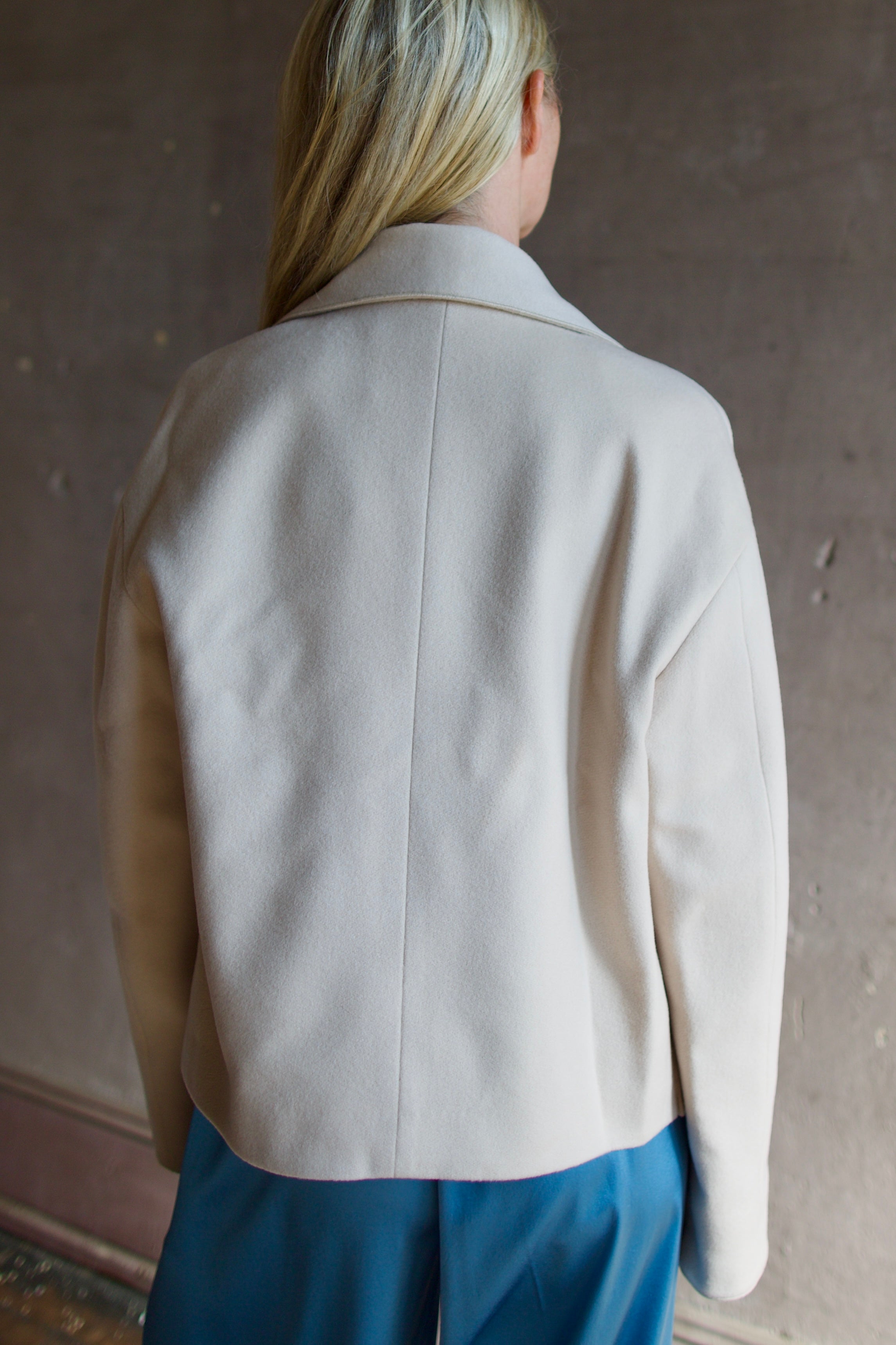 Model wearing expertly tailored Forte Forte beige jacket in premium virgin wool and cashmere 