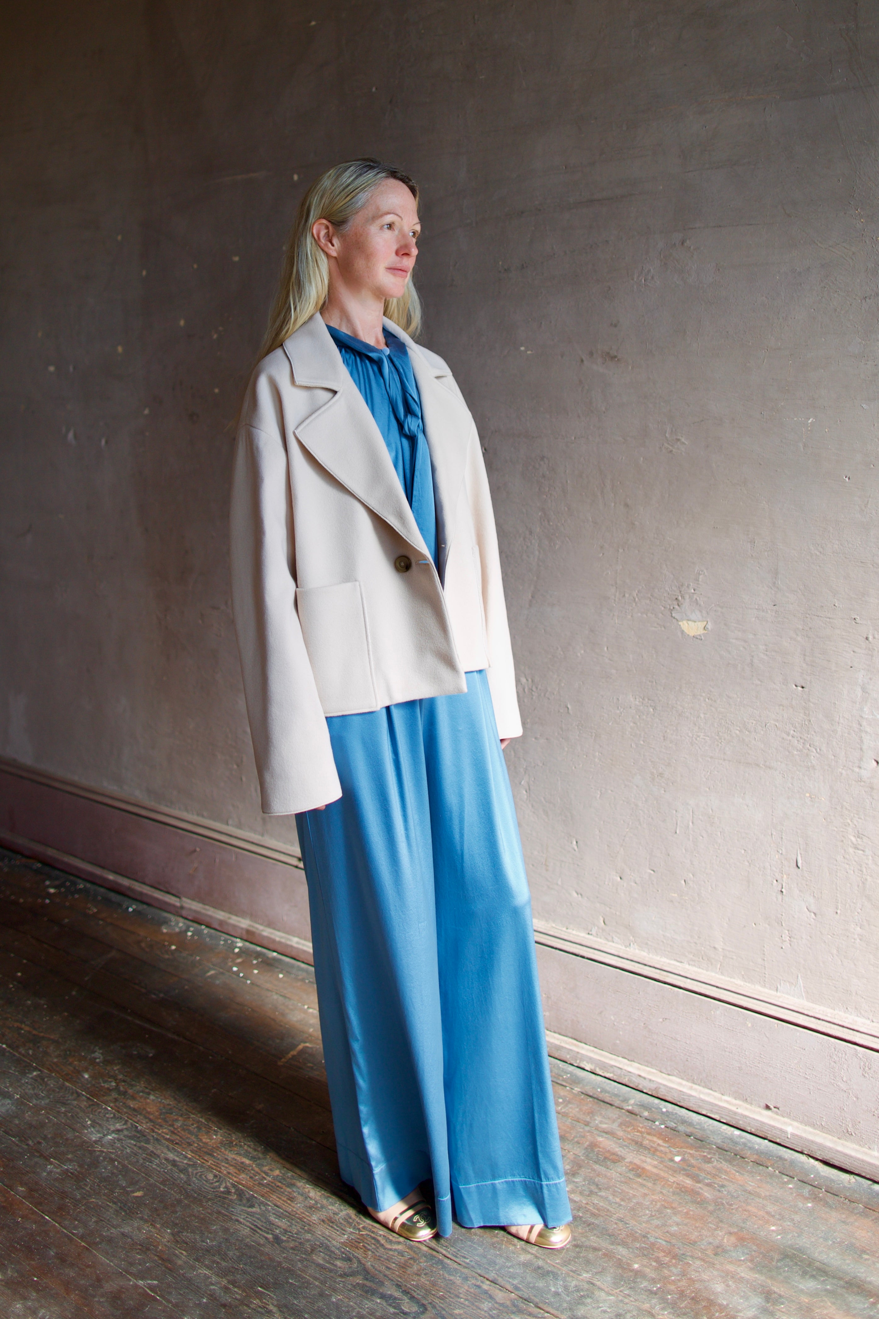 Model wearing expertly tailored Forte Forte beige jacket in premium virgin wool and cashmere with front pockets and button closure