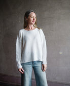 Image featuring a woman wearing the alpaca mohair boucle sweater by Forte Forte with a crew neckline, long sleeve and relaxed fit in ivory.