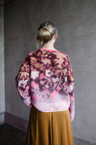 Image featuring a woman wearing the bloom mist mohair and alpaca sweater by Forte Forte with a crew neckline and slightly boxy fit in cerise multicolor floral print.