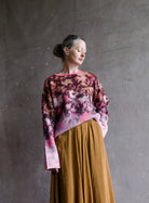 Image featuring a woman wearing the bloom mist mohair and alpaca sweater by Forte Forte with a crew neckline and slightly boxy fit in cerise multicolor floral print.