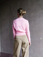 Image featuring a woman wearing the pink cashmere wool gauze sweater by Forte Forte with a crew neckline and tailored fit.