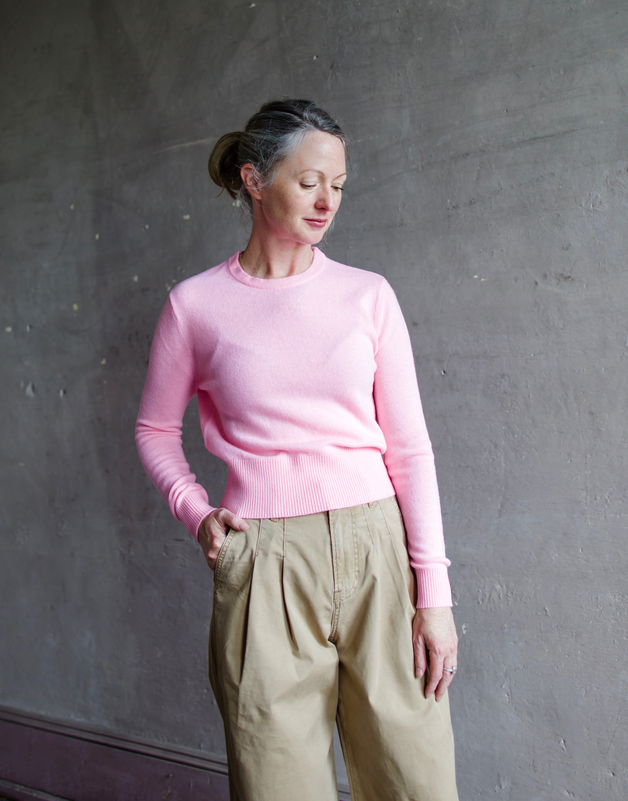 Image featuring a woman wearing the pink cashmere wool gauze sweater by Forte Forte with a crew neckline and tailored fit.