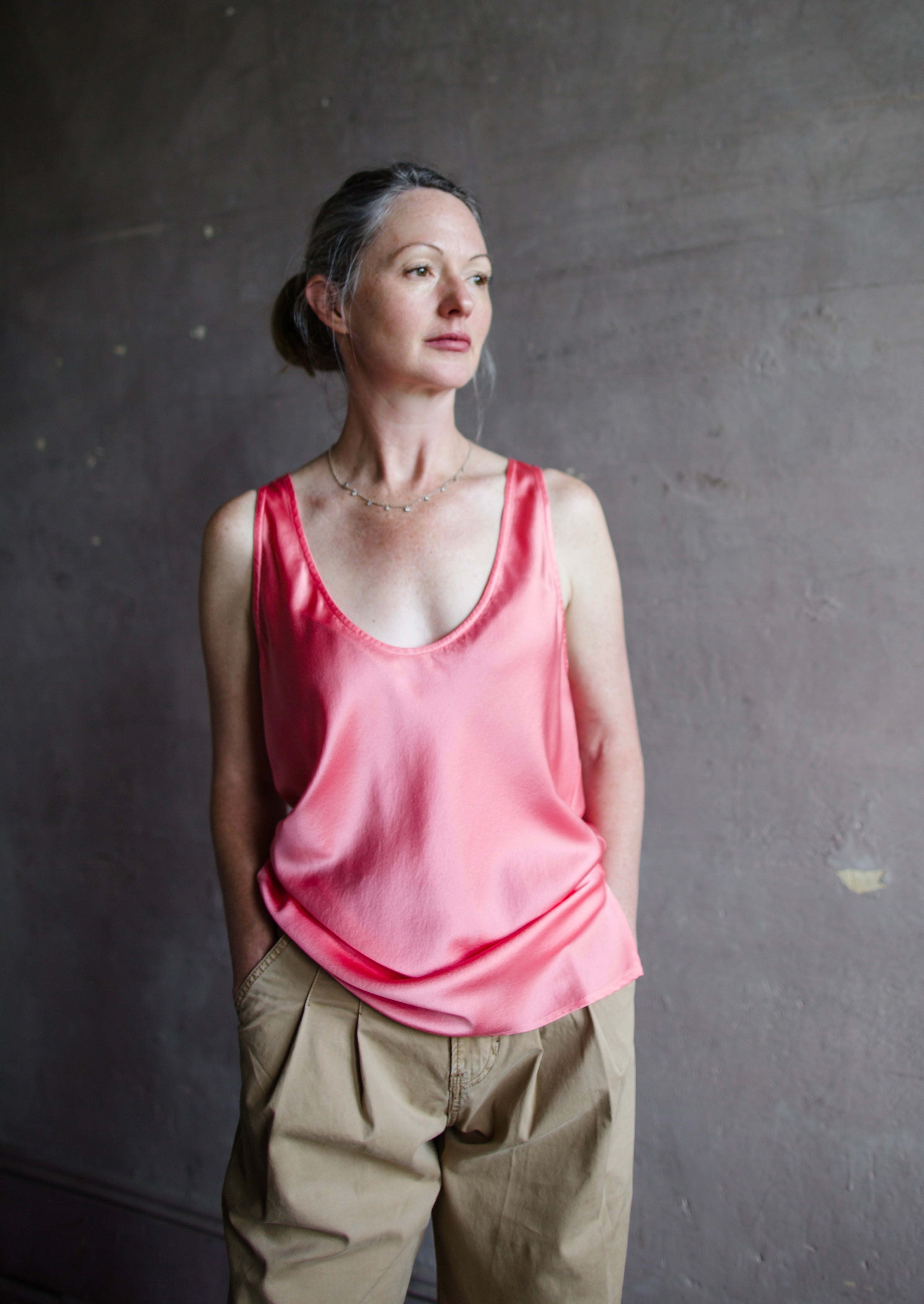 Image featuring a woman wearing the pink heavy satin silk tank by Forte Forte with a scoop neckline and relaxed fit.