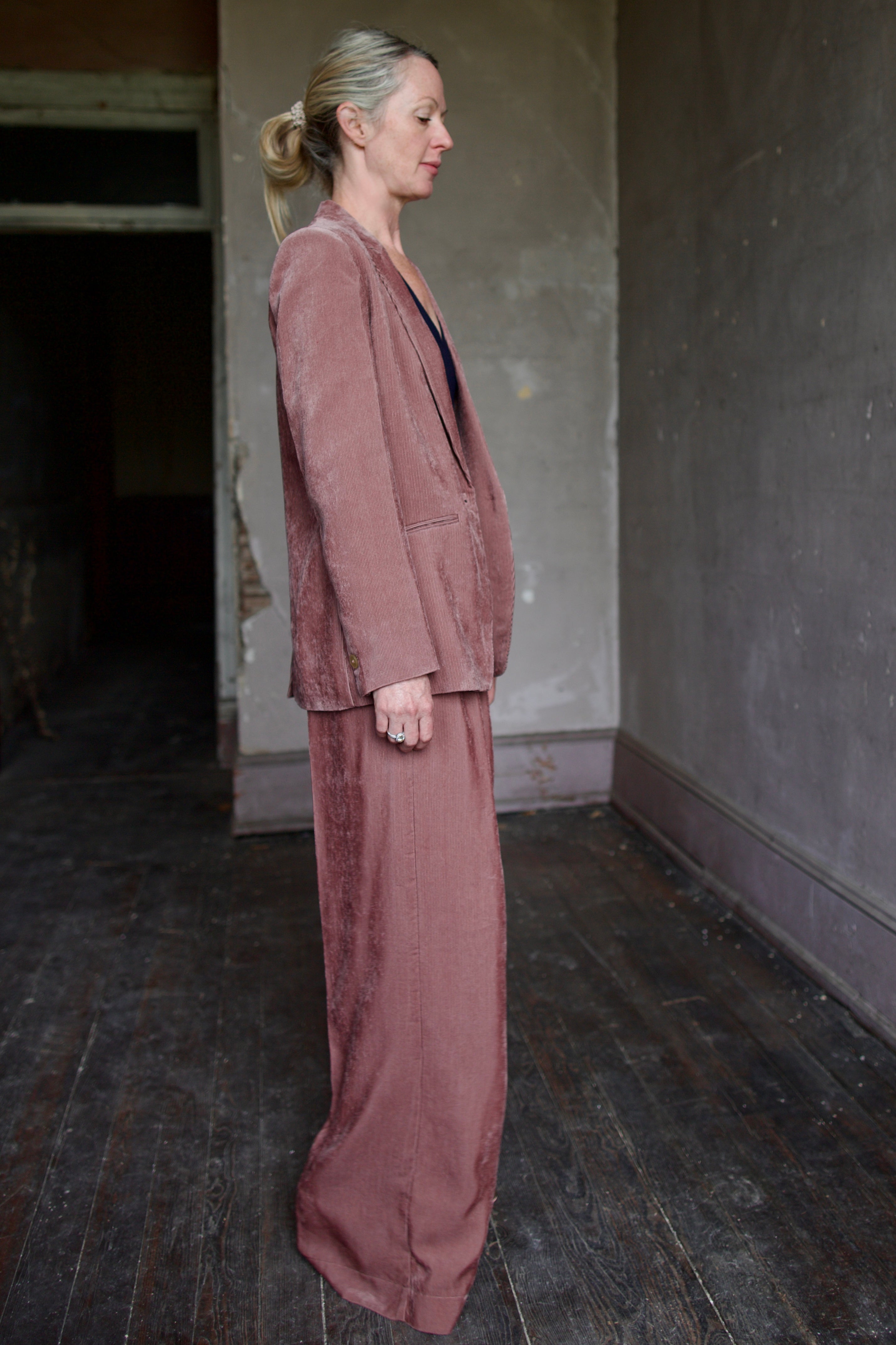 Mature model wearing high-end Italian fashion designer Forte Forte mauve velvet corduroy blazer and pant set 