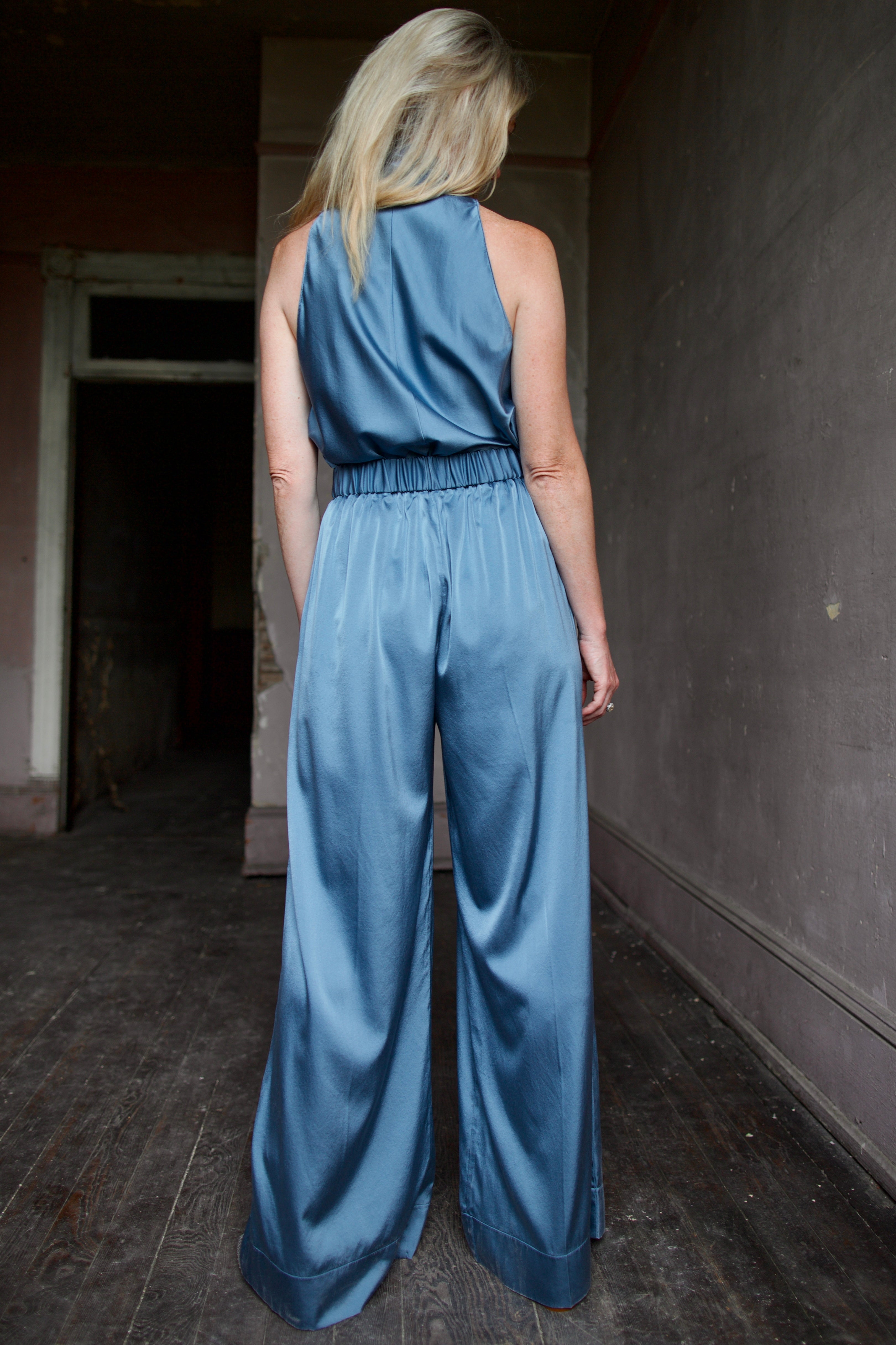 Mature model wearing luxury women's clothing Italian designer Forte Forte blue silk top and pant set 