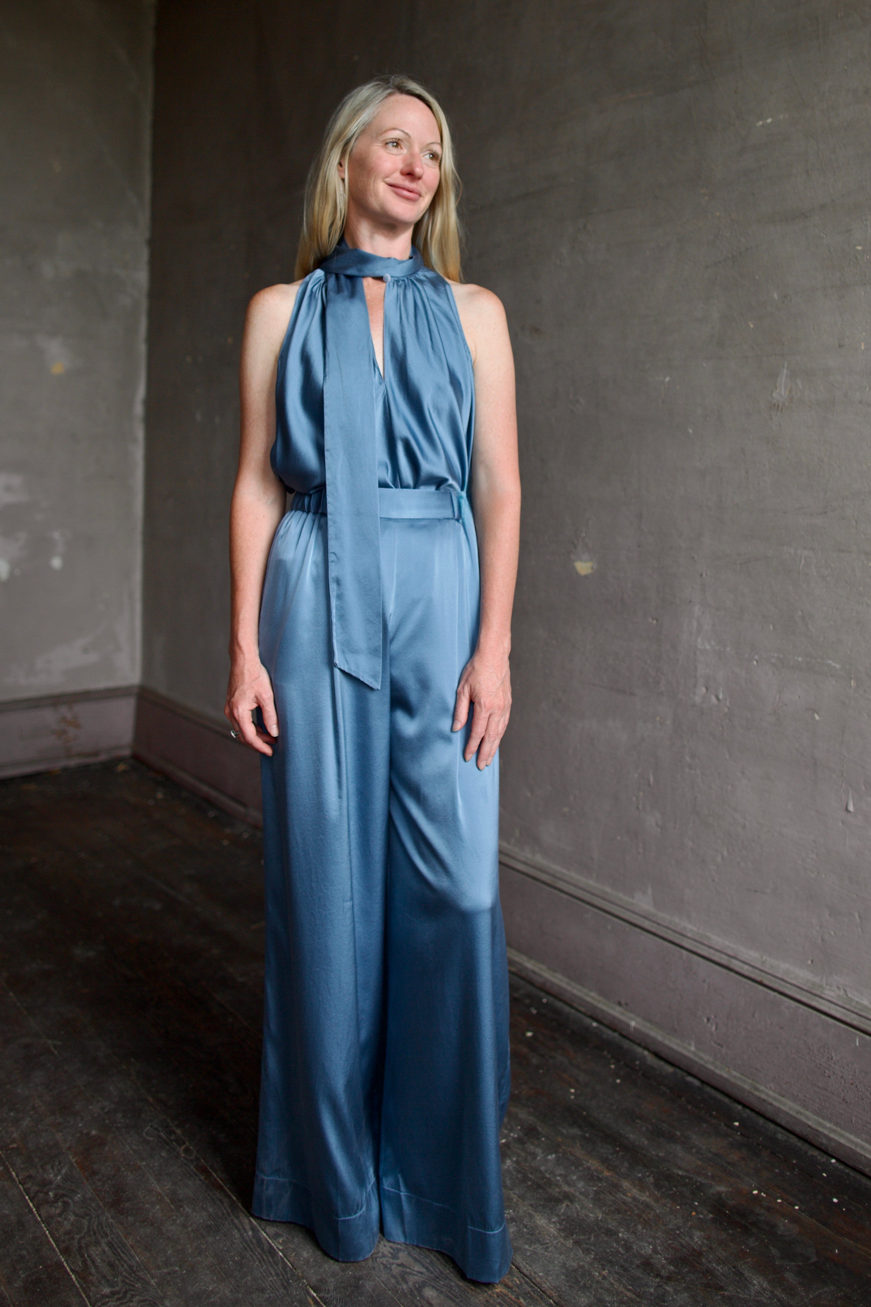 Mature model wearing luxury women's clothing Italian designer Forte Forte blue silk top and pant set 