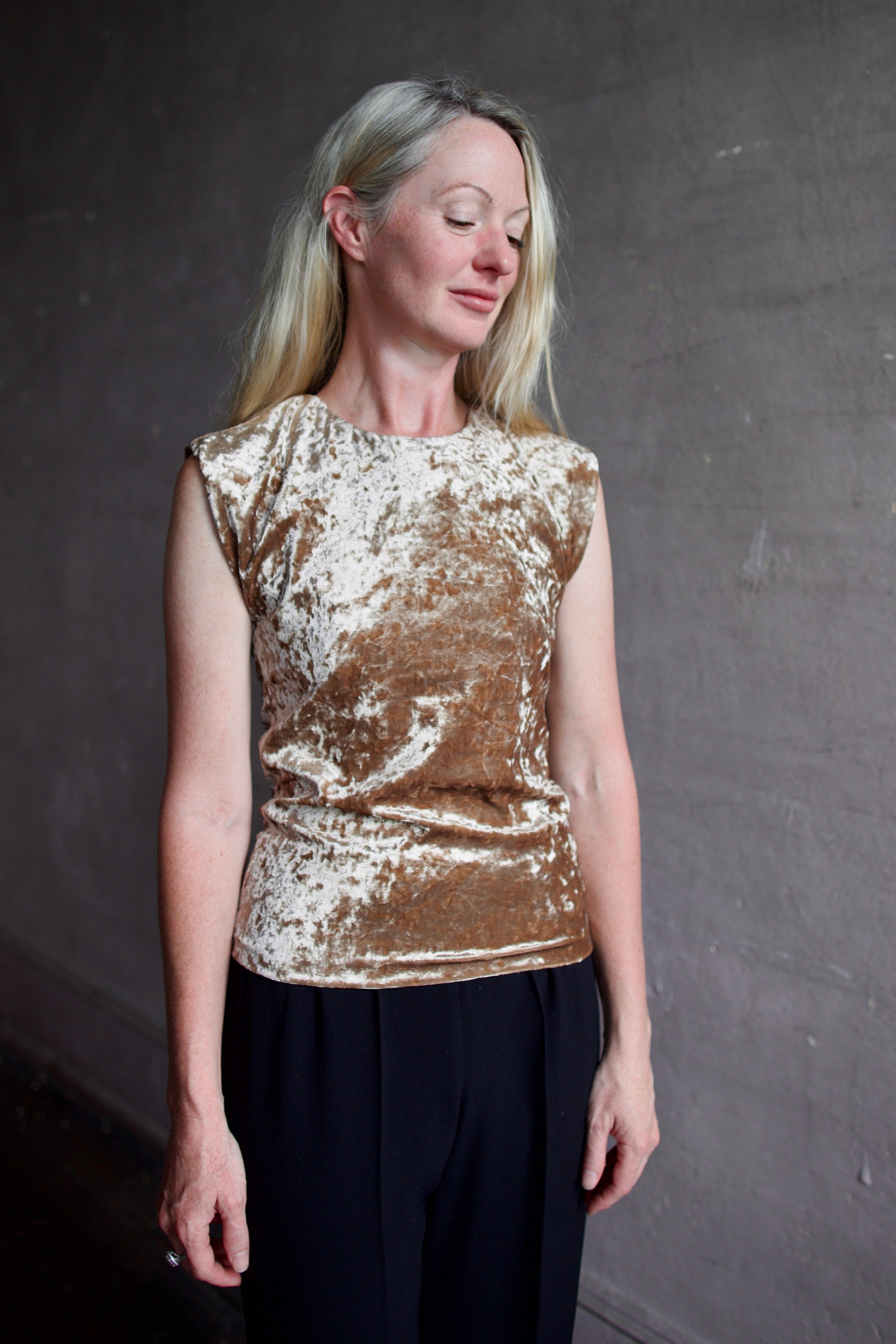 Mature model wearing sleeveless velvet top paired with timeless tuxedo stripe trousers from high-end Italian designer Forte_Forte