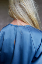 Close up showing back details of high-end Italian fashion designer Forte Forte short sleeve blue blouse