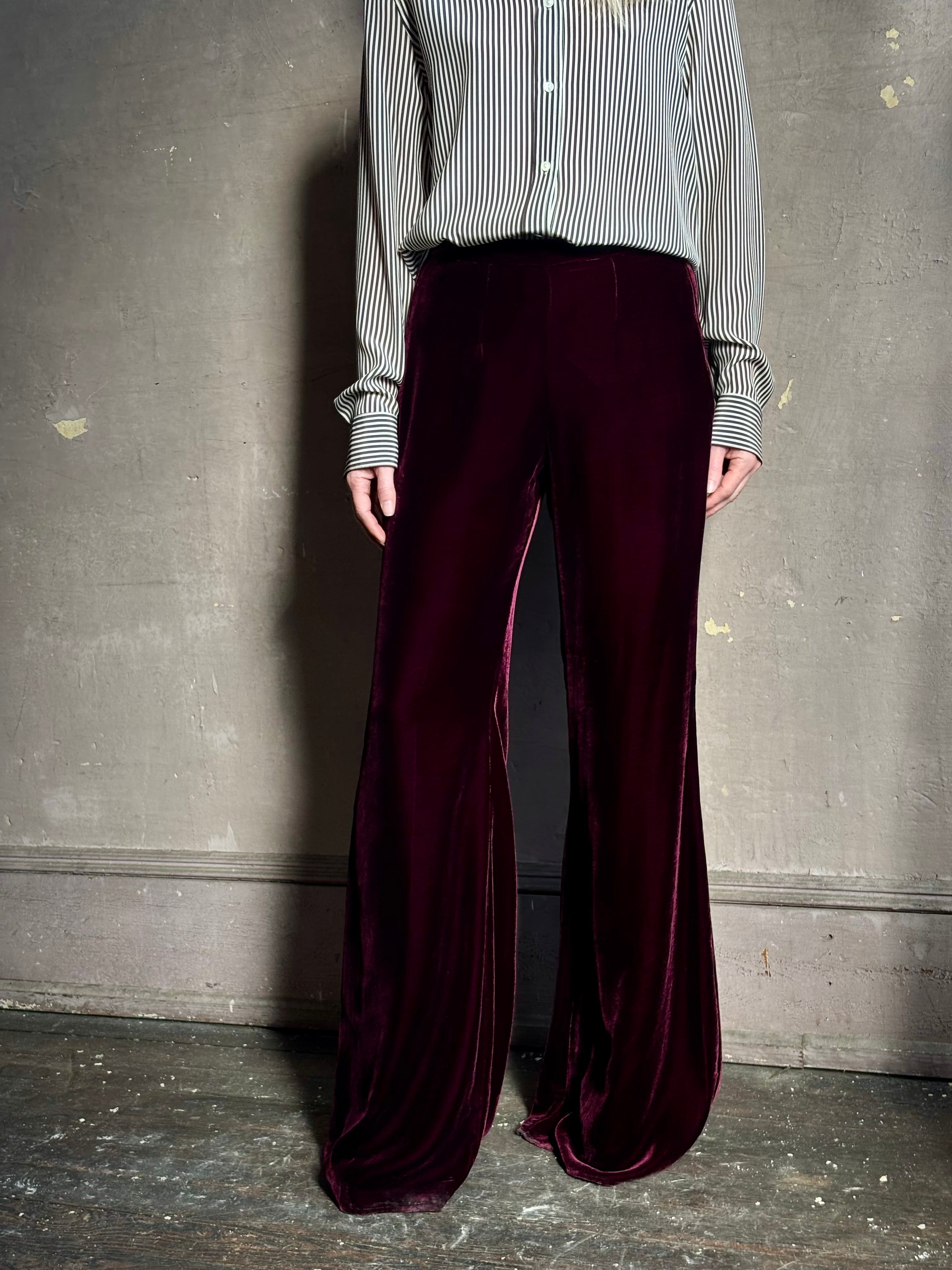 Close up of Forte_Forte Plain Velvet Flare Pants in Burgundy fitted flat front with tailored waistband fluid leg full length consealed side seam zipper