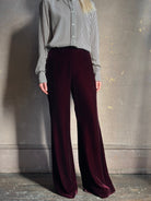 Close up of Forte_Forte Plain Velvet Flare Pants in Burgundy velvet fitted flat front fluid flare leg consealed side seam zipper