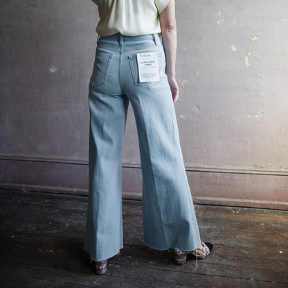 Image featuring a woman wearing  high-rise cropped silhouette jean from Frame with a frayed, swingy hem and crafted from a lightweight, super-stretch cotton blend.